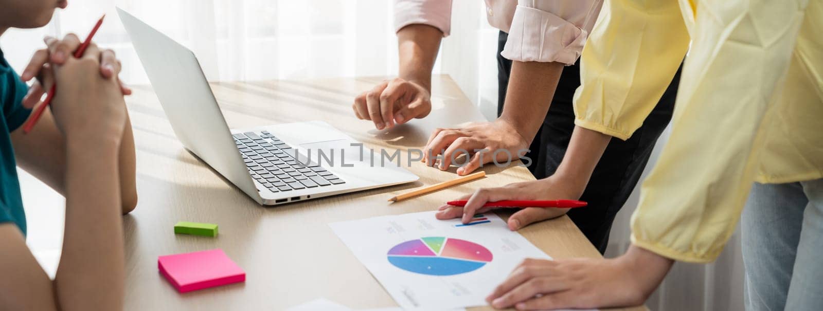 Startup company employee working together, analyzing BI dashboard paper on financial data report and planning strategic marketing for business success in panorama banner. Synergic