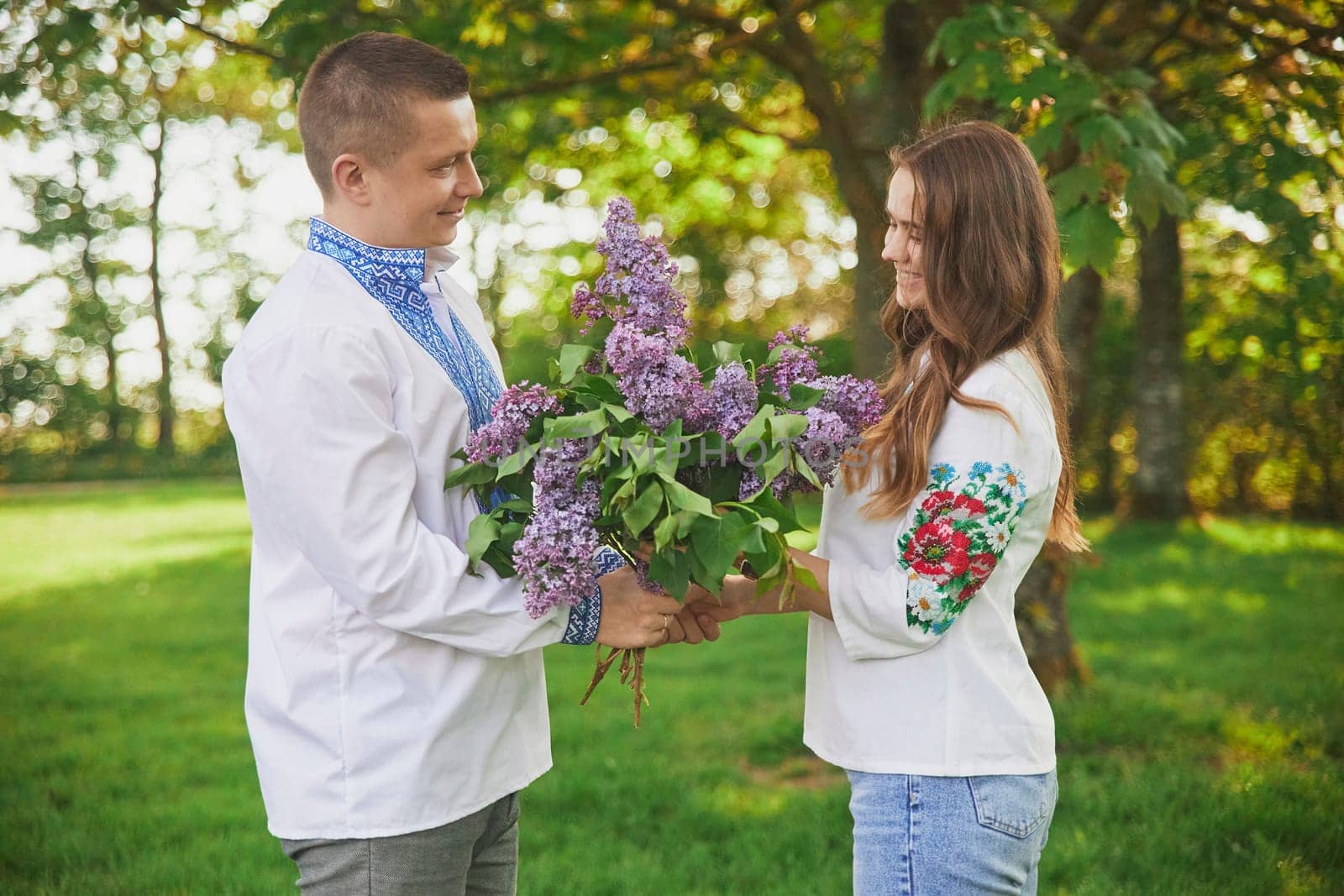 Skjern, Denmark, May 21, 2023: couple in love in national Ukrainian clothes. Man gives flowers