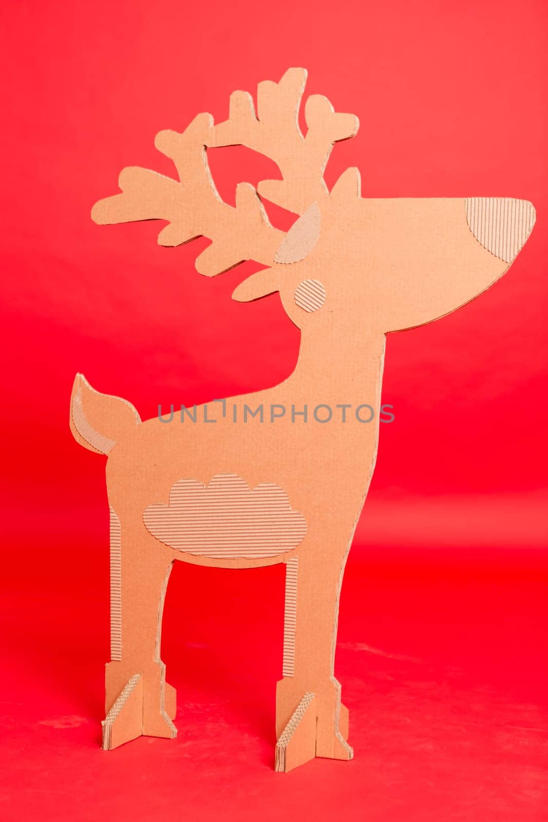 Deer from recycling cardboard. Space for text.