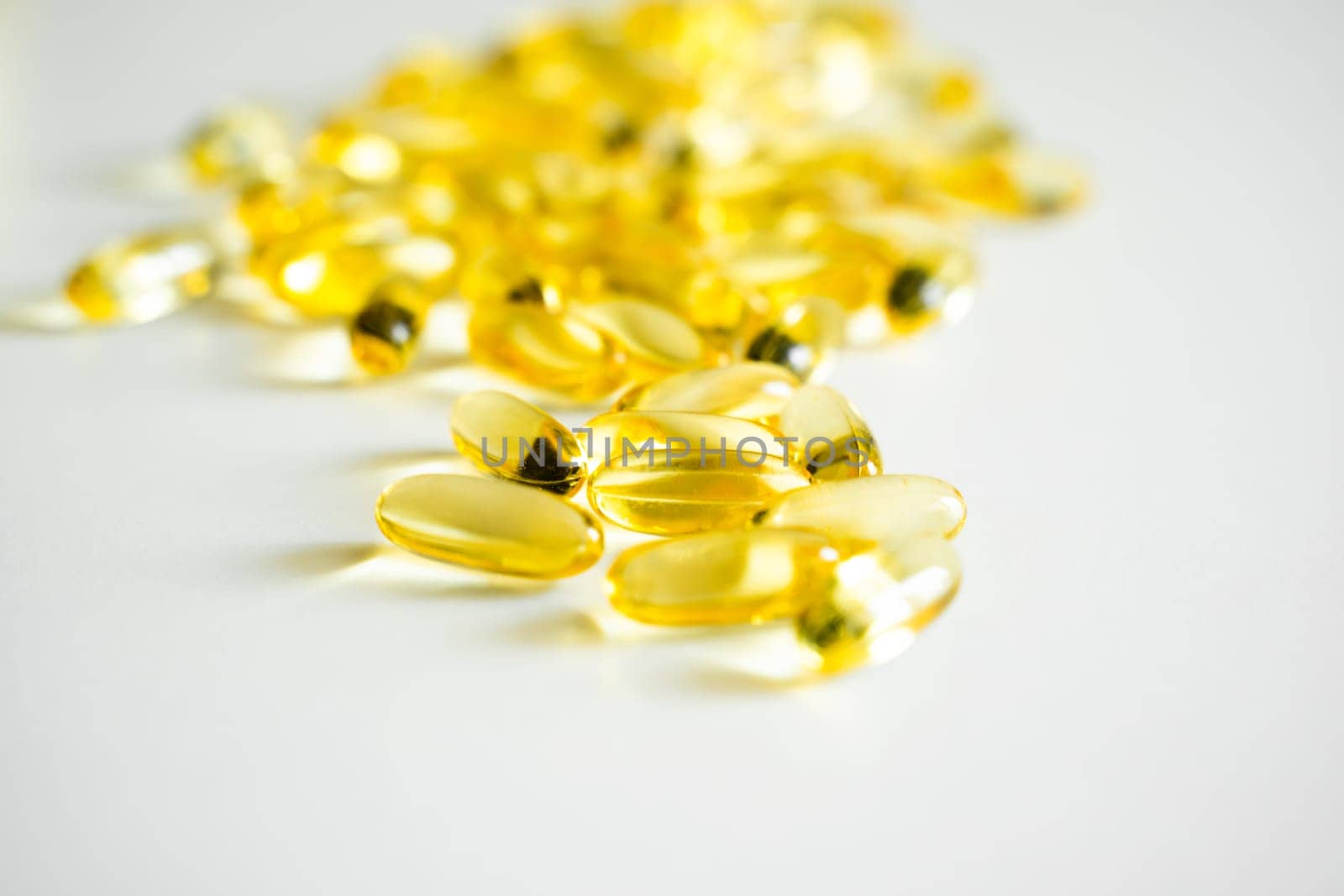 Capsules of Omega 3 on white background. Health care concept. Medical pill or vitamin's capsule pattern. Medicine, healthcare or pharmacy concept. by vovsht