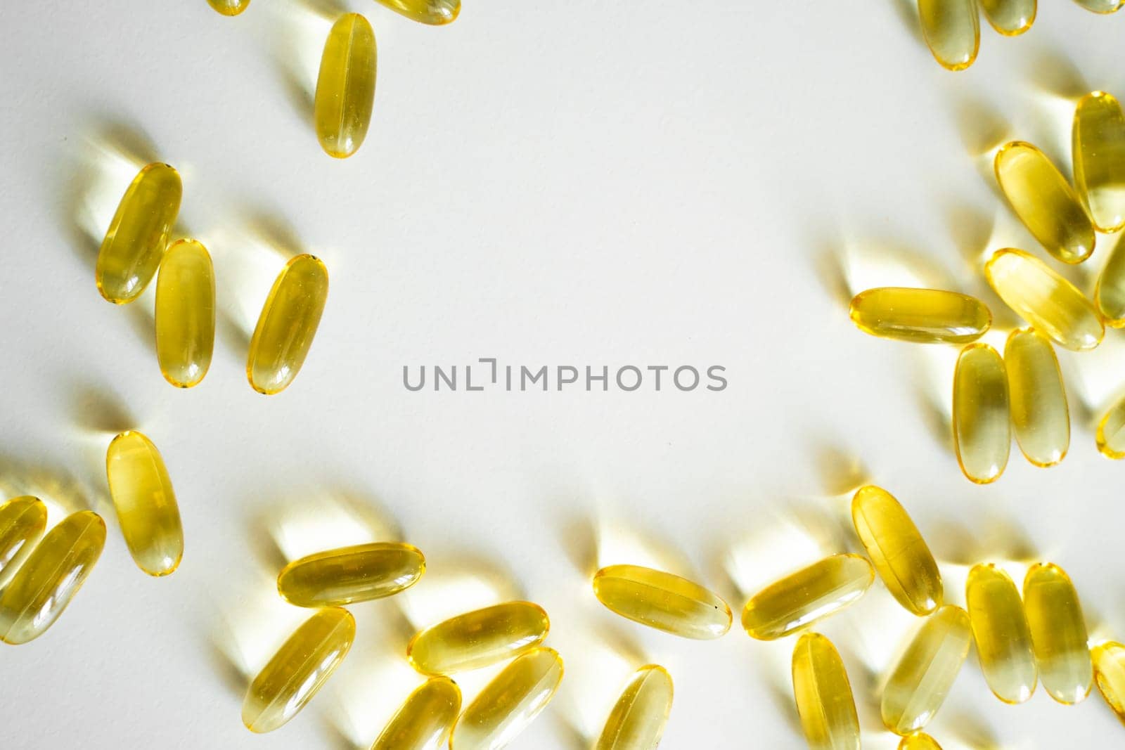 Close up capsules of Omega 3 on white background. Health care concept. Medical pill or vitamin's capsule pattern. Medicine, healthcare or pharmacy concept. by vovsht