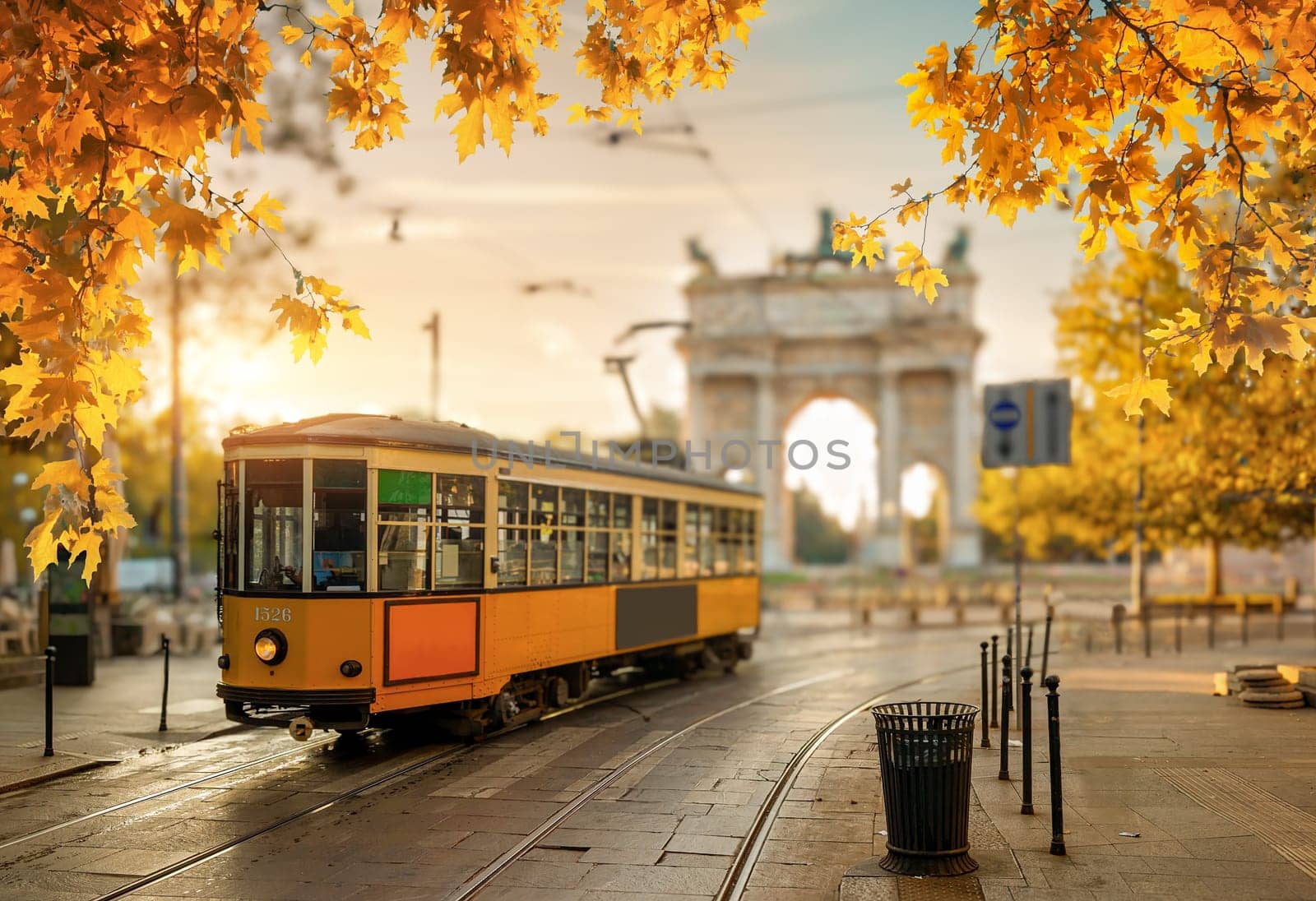 View of the Peace Arch with yellow tram in Milan, Italy