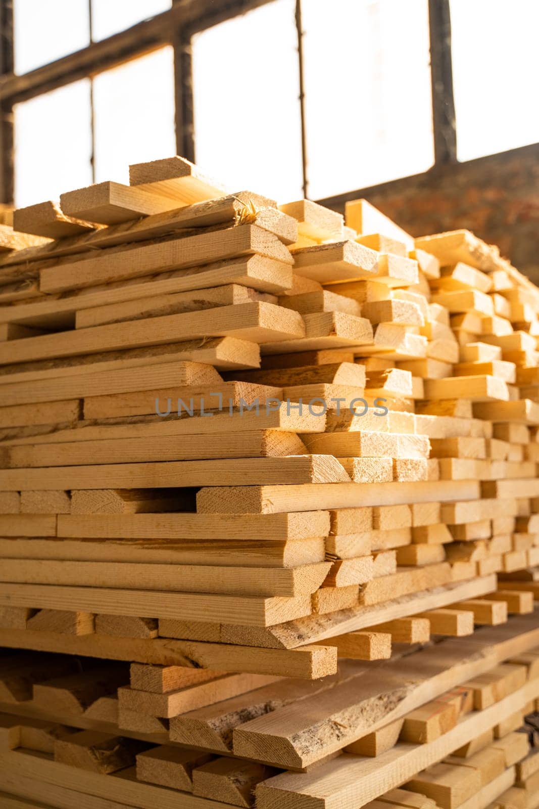 Stacked wooden planks in close-up at a outdoor lumber warehouse. Drying timber stack. Wood air drying
