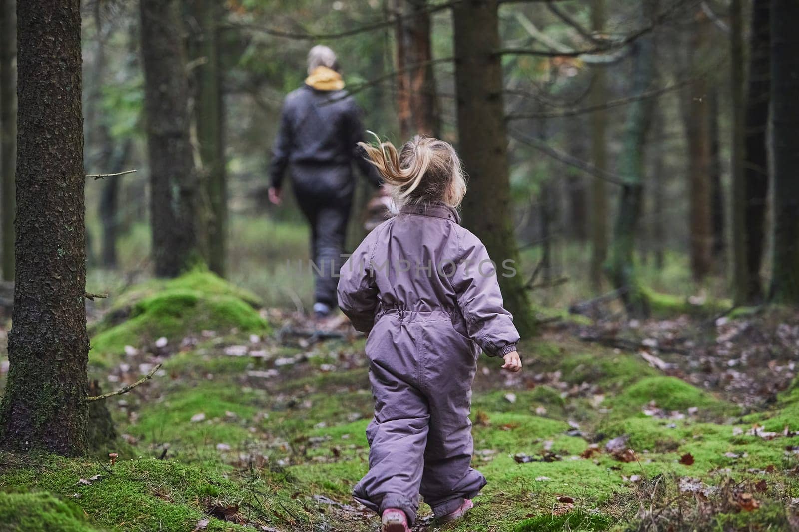 Mother with daughter walk in the forest in Denmark.
