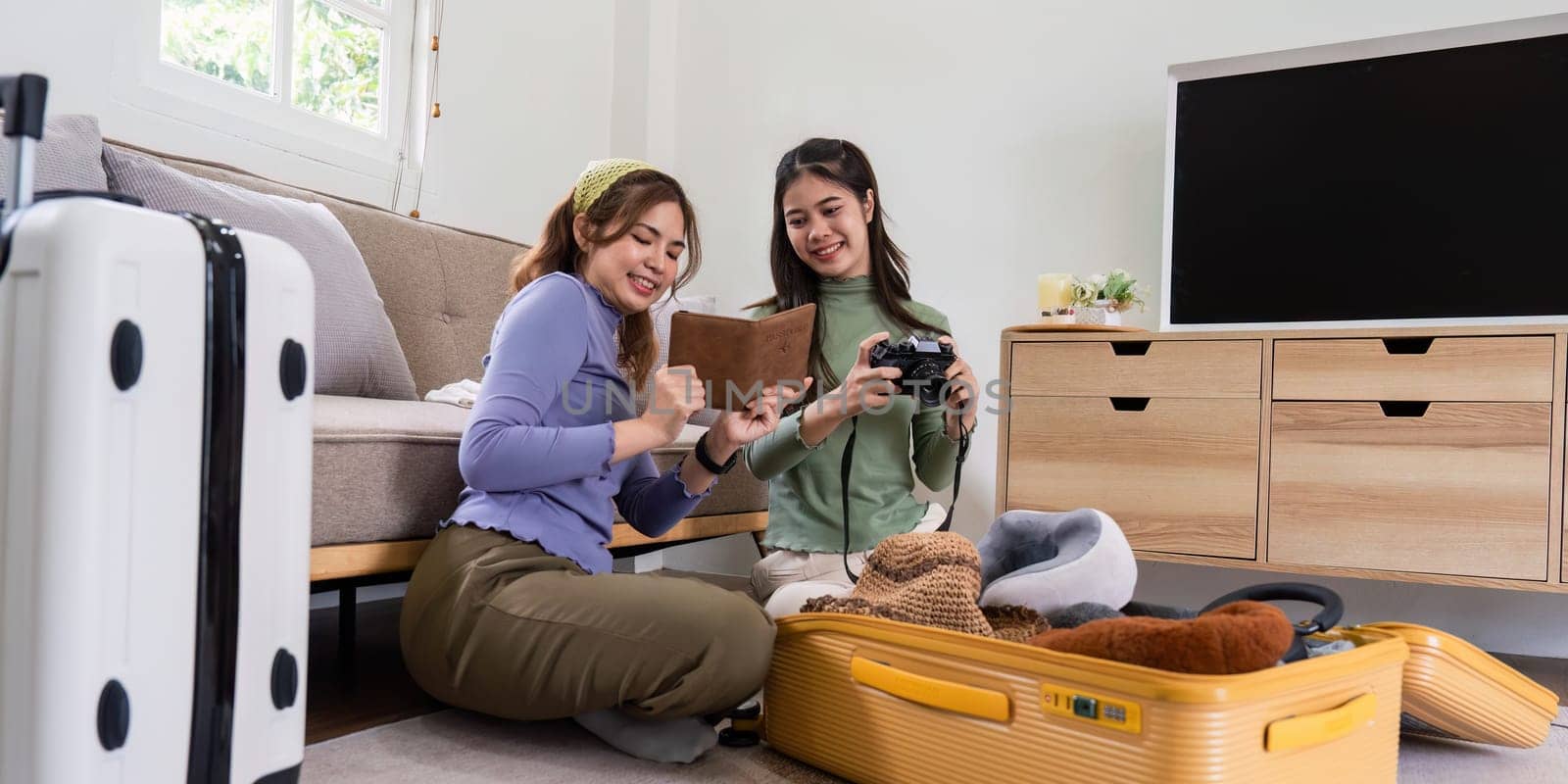 Woman and friend packing a suitcase for a new travel trip. bag and luggage for journey by itchaznong