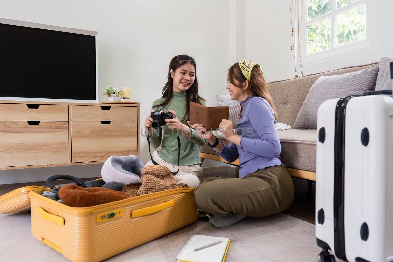 Woman and friend packing a suitcase for a new travel trip. bag and luggage for journey.