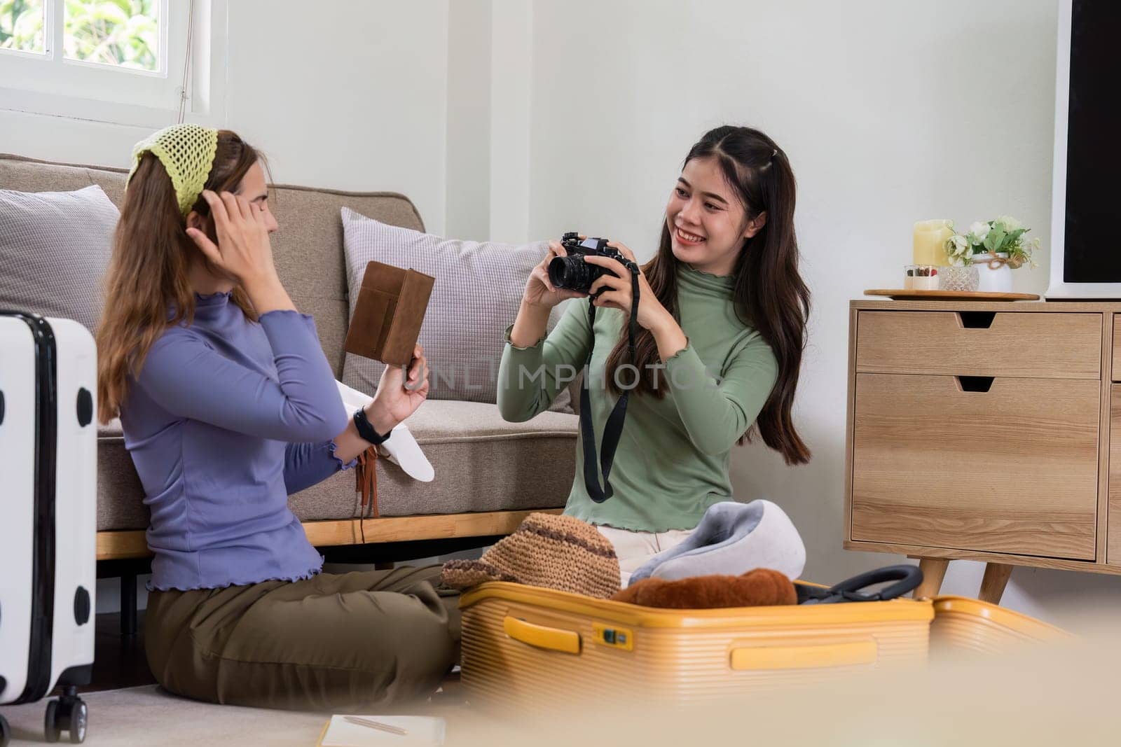 Woman and friend packing a suitcase for a new travel trip. bag and luggage for journey.