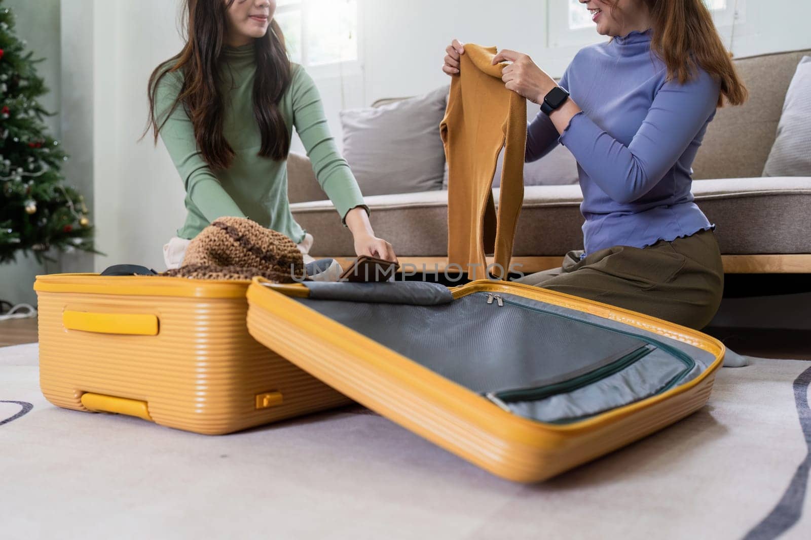 Woman and friend packing a suitcase for a new travel trip. bag and luggage for journey.