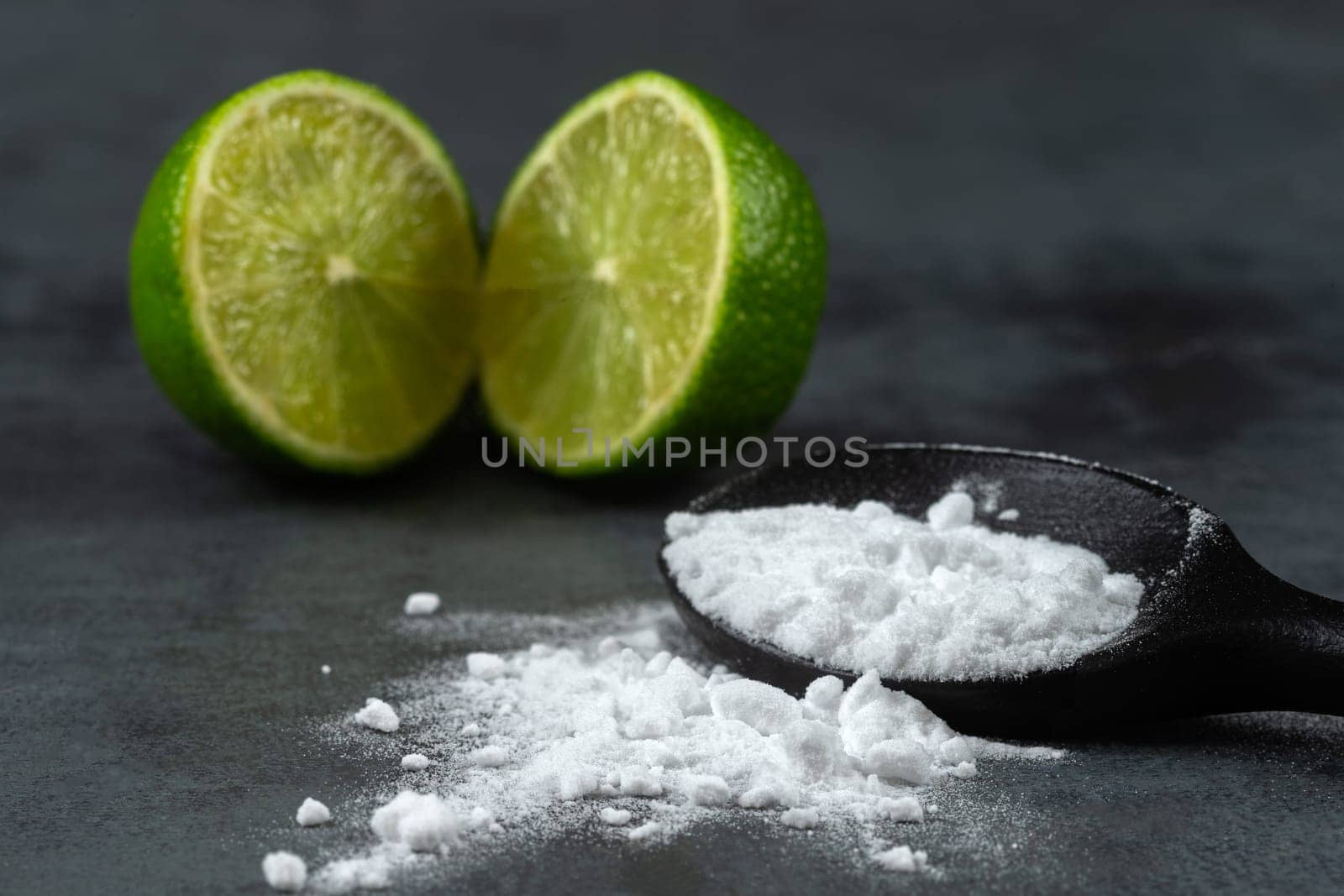 Baking soda, and cut lemons on grey painted wooden table, .