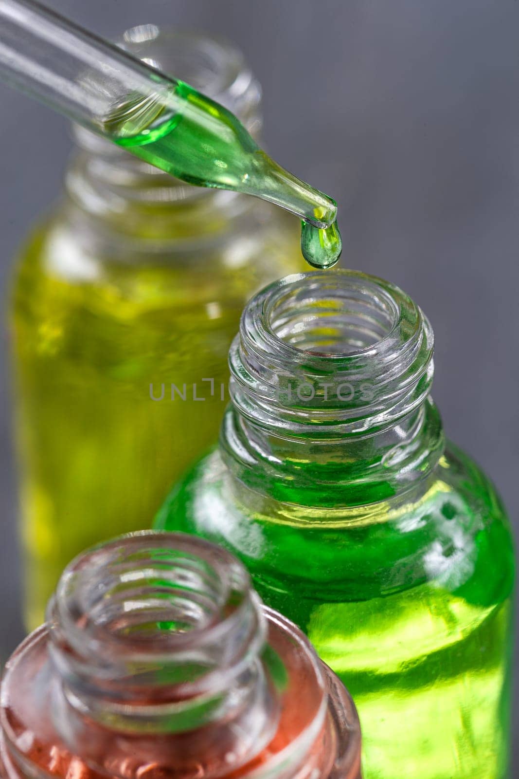 essential oil falling from glass dropper profile view by JPC-PROD