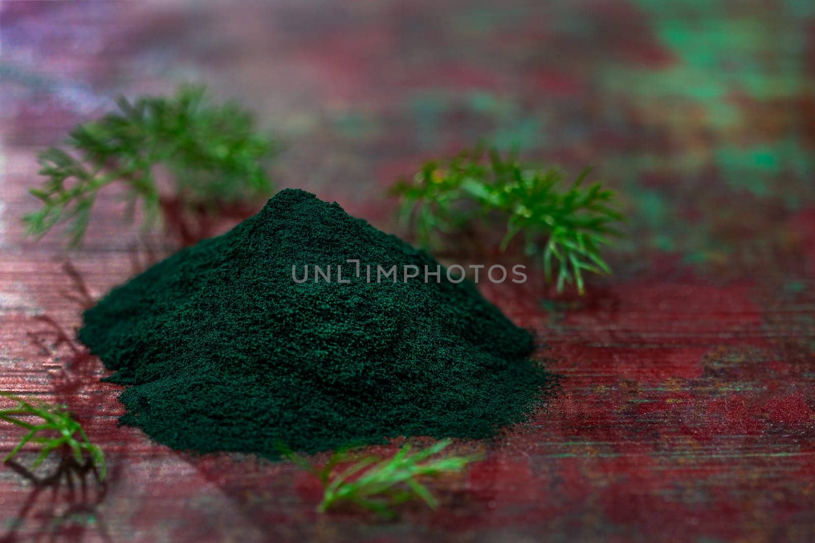 Organic green spirulina powder top view wooden background. Super foods, food supplement