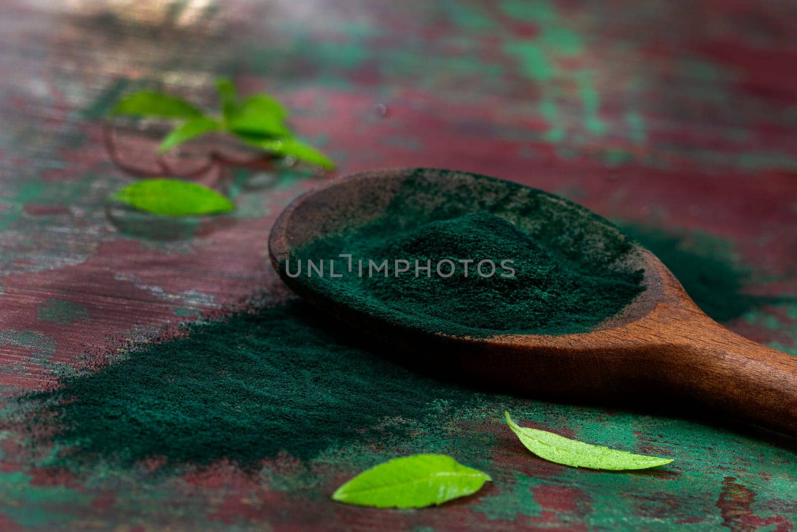 Organic green spirulina powder top view on wooden spoon background. Super foods, by JPC-PROD