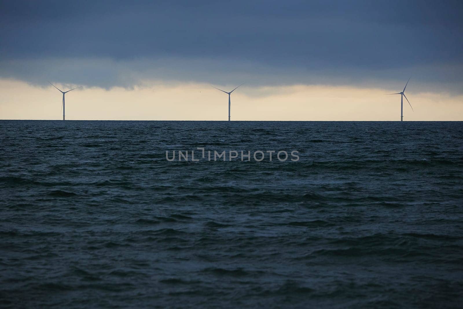 Wind turbines in the North Sea in Denmark in the evening.