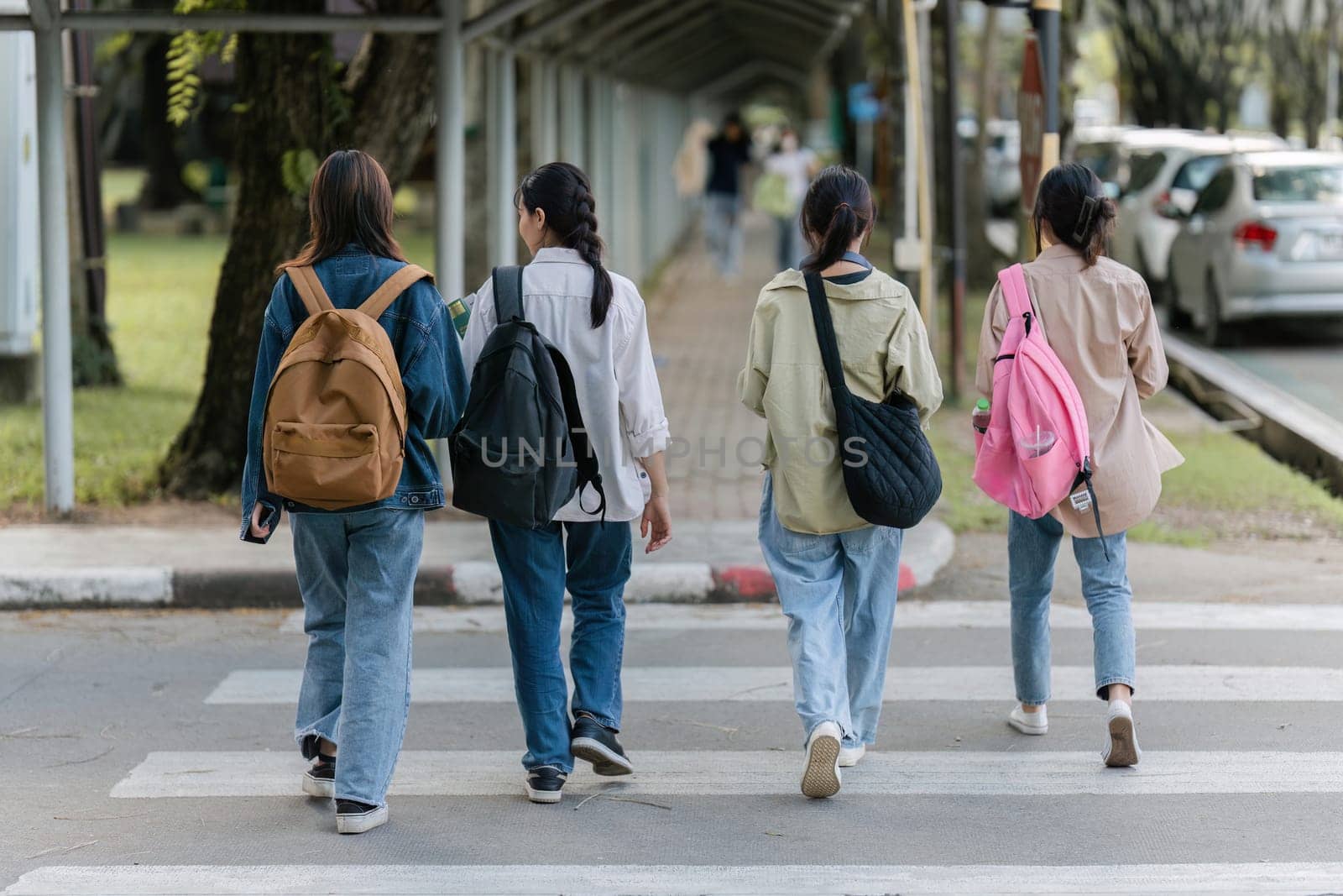 Group of Young Asian student walking and talking at university before class room. education, back to school concept by itchaznong