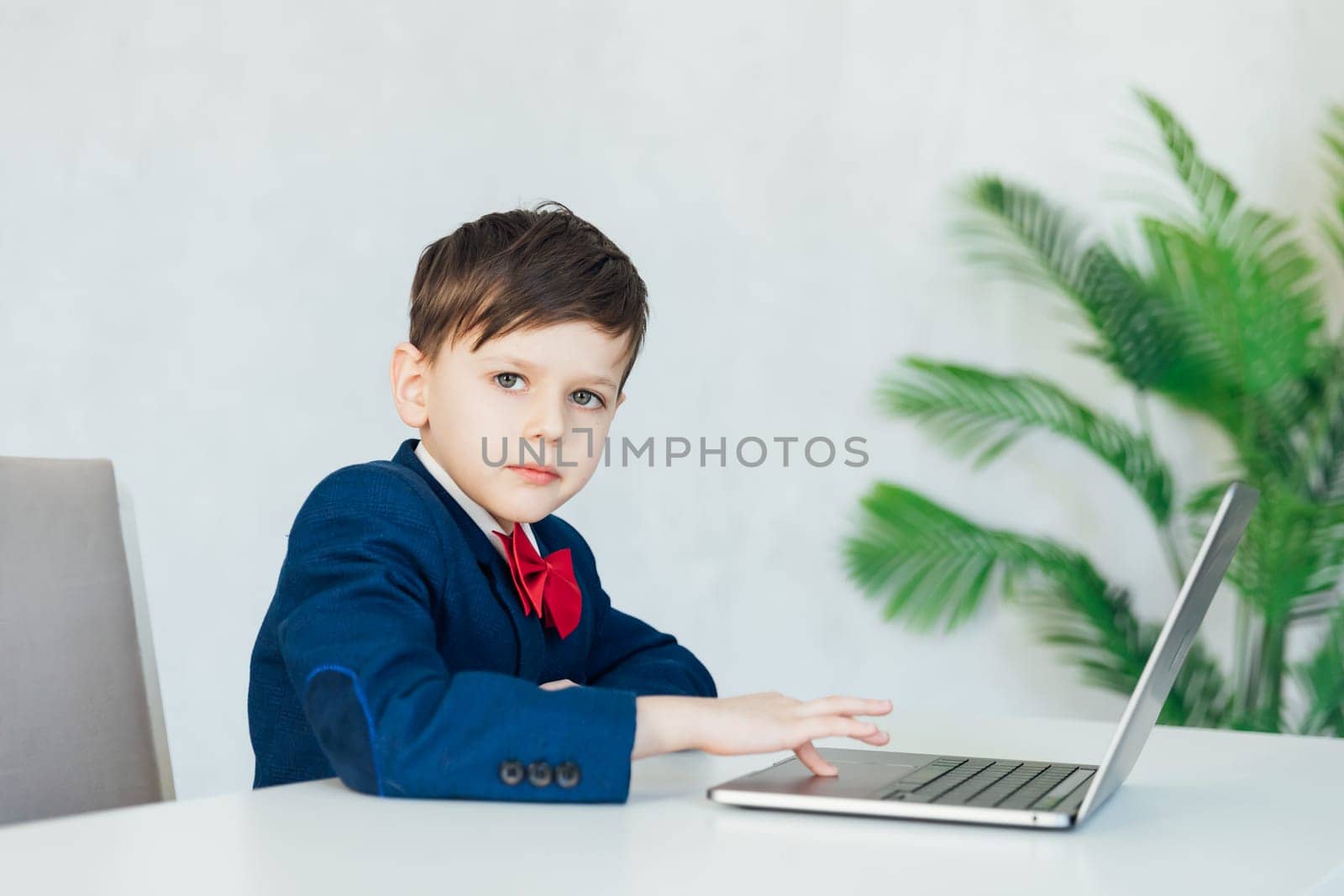 pupil lessons education boy schoolboy learns at the computer online school in the classroom by Simakov