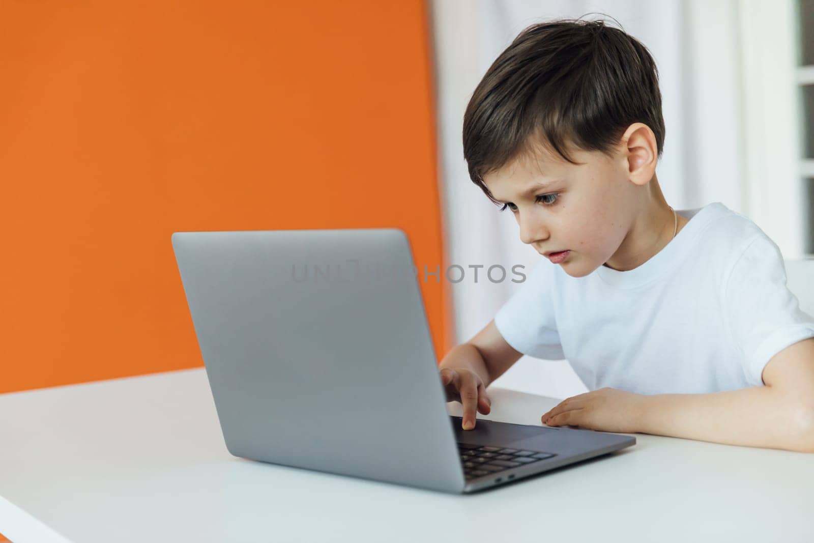 online school in the classroom homeschooling student education lessons boy schoolboy learns at the computer by Simakov