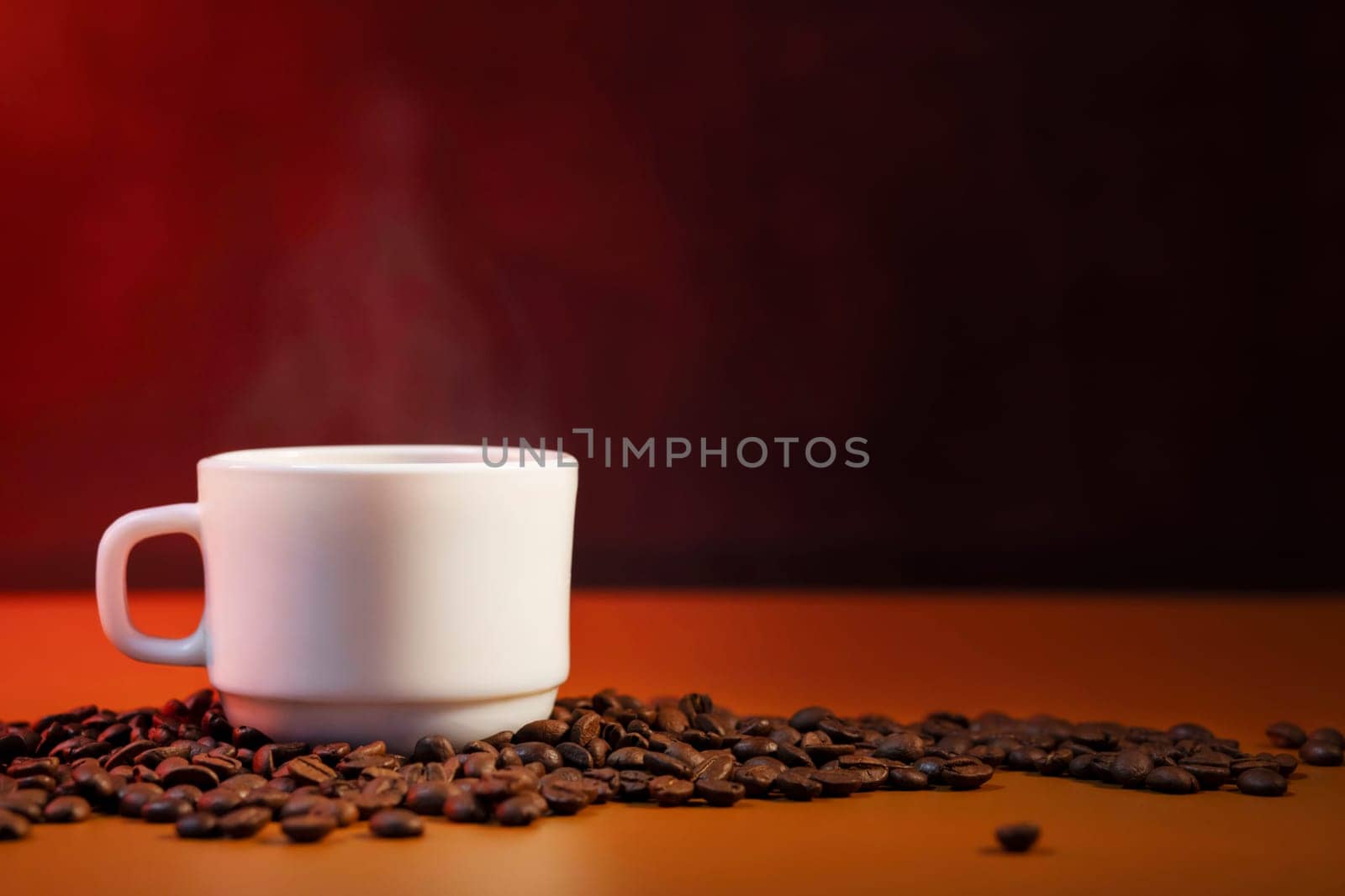 Coffee cup with smoke and freshly roasted coffee beans with copy space.