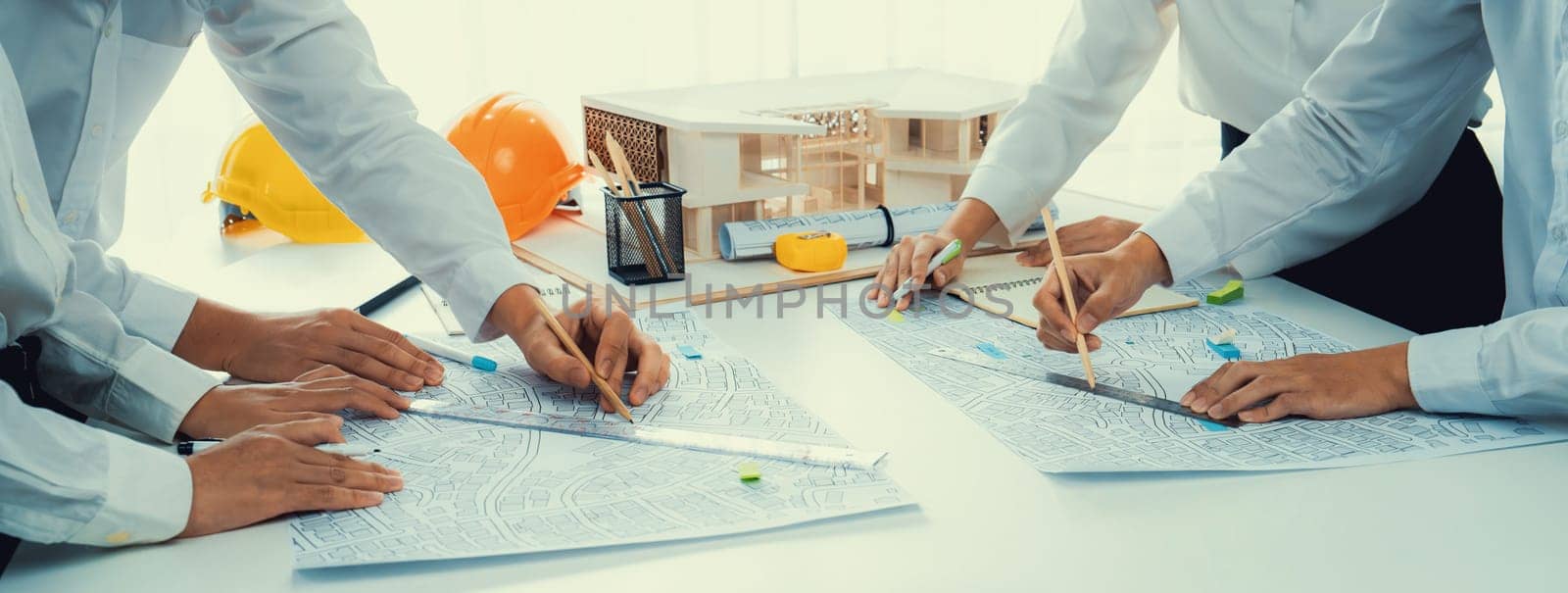 Worker, architect and engineer work on real estate construction project oratory planning with cartography and cadastral map of urban town area to guide to construction developer business plan of city