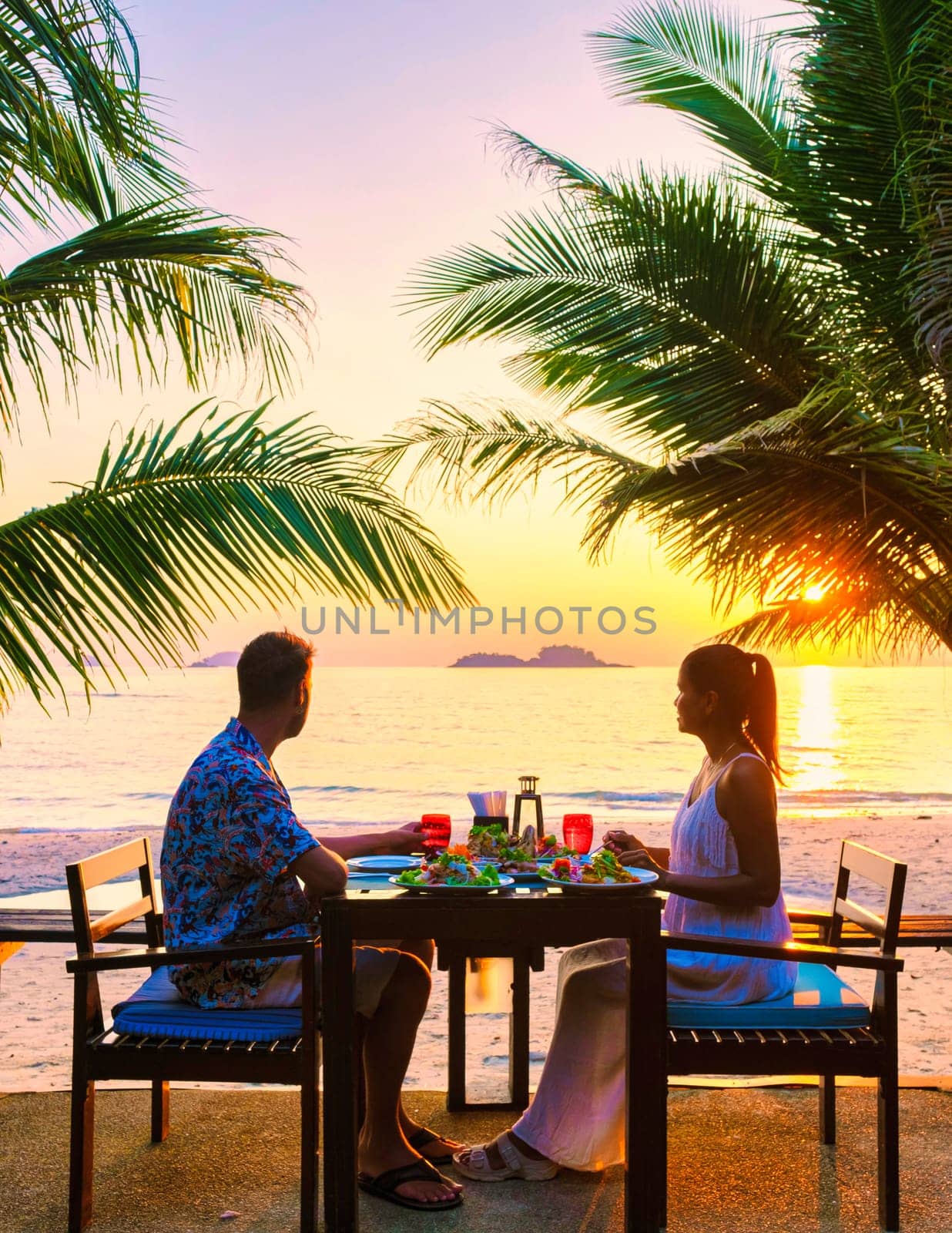 couple having a romantic dinner on the beach of Koh Chang Thailand by fokkebok