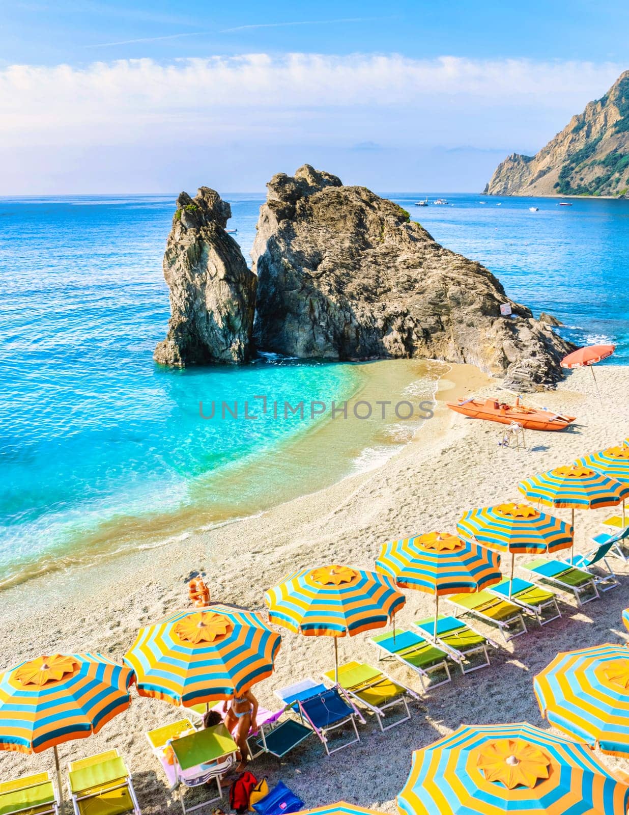 Pebble beach of Monterosso vacation Cinque Terre Monterosso Chairs and umbrellas fill the Spiaggia di Fegina beach Monterosso part of the Cinque Terre Italy.