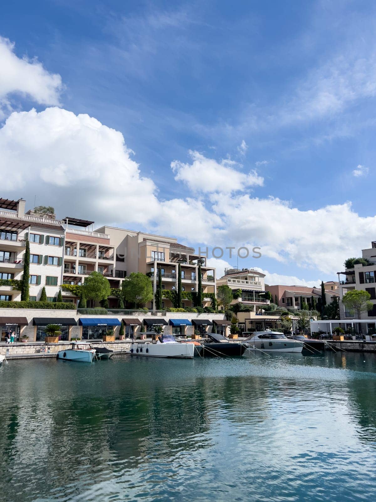 Tivat, Montenegro - 11 august 2023: Coast of the town of Porto with colorful villas, expensive boutiques and marina by Nadtochiy