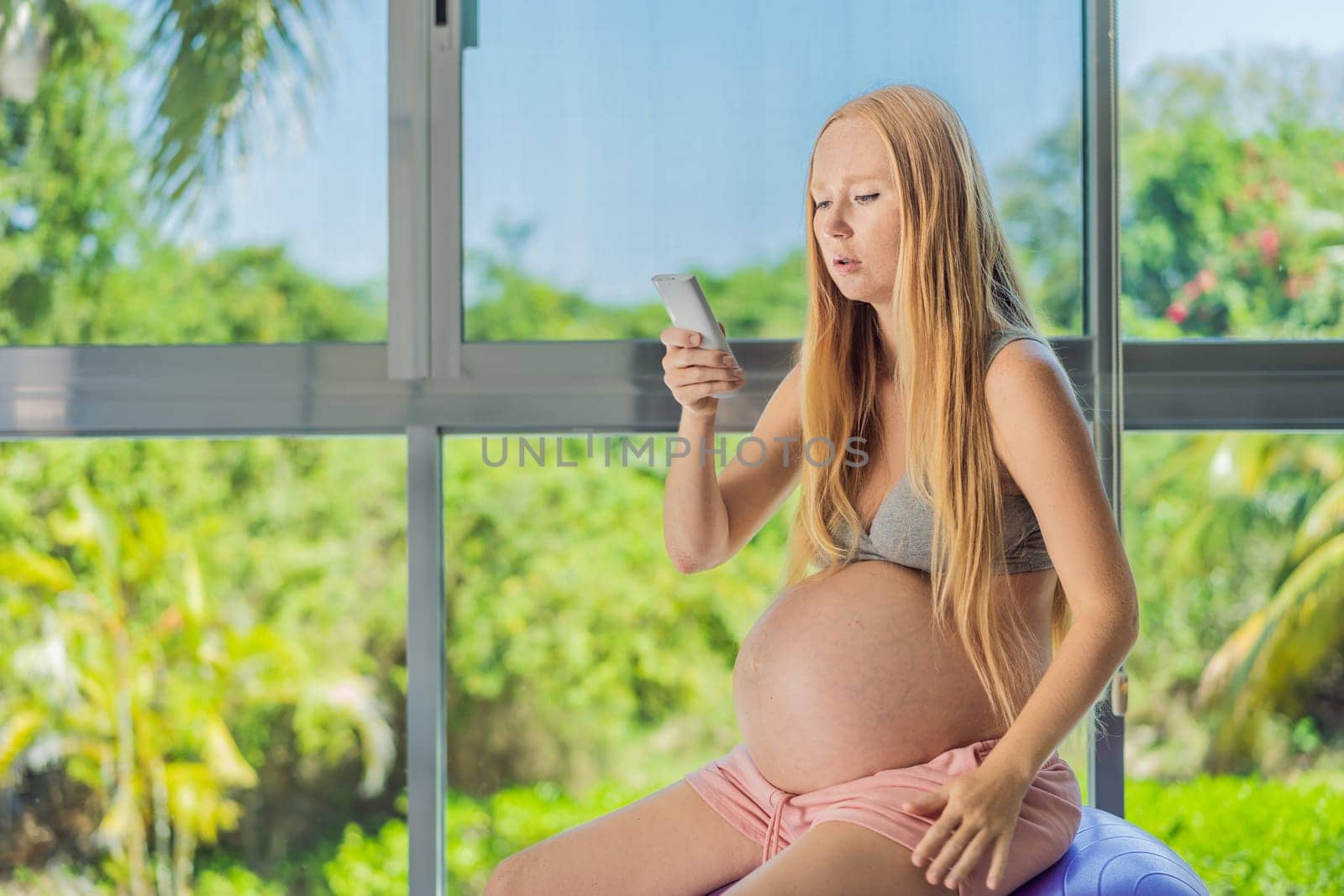 In the midst of a hot day, a pregnant woman finds relief and comfort as she enjoys the cooling embrace of air conditioning, ensuring a soothing and relaxing atmosphere by galitskaya