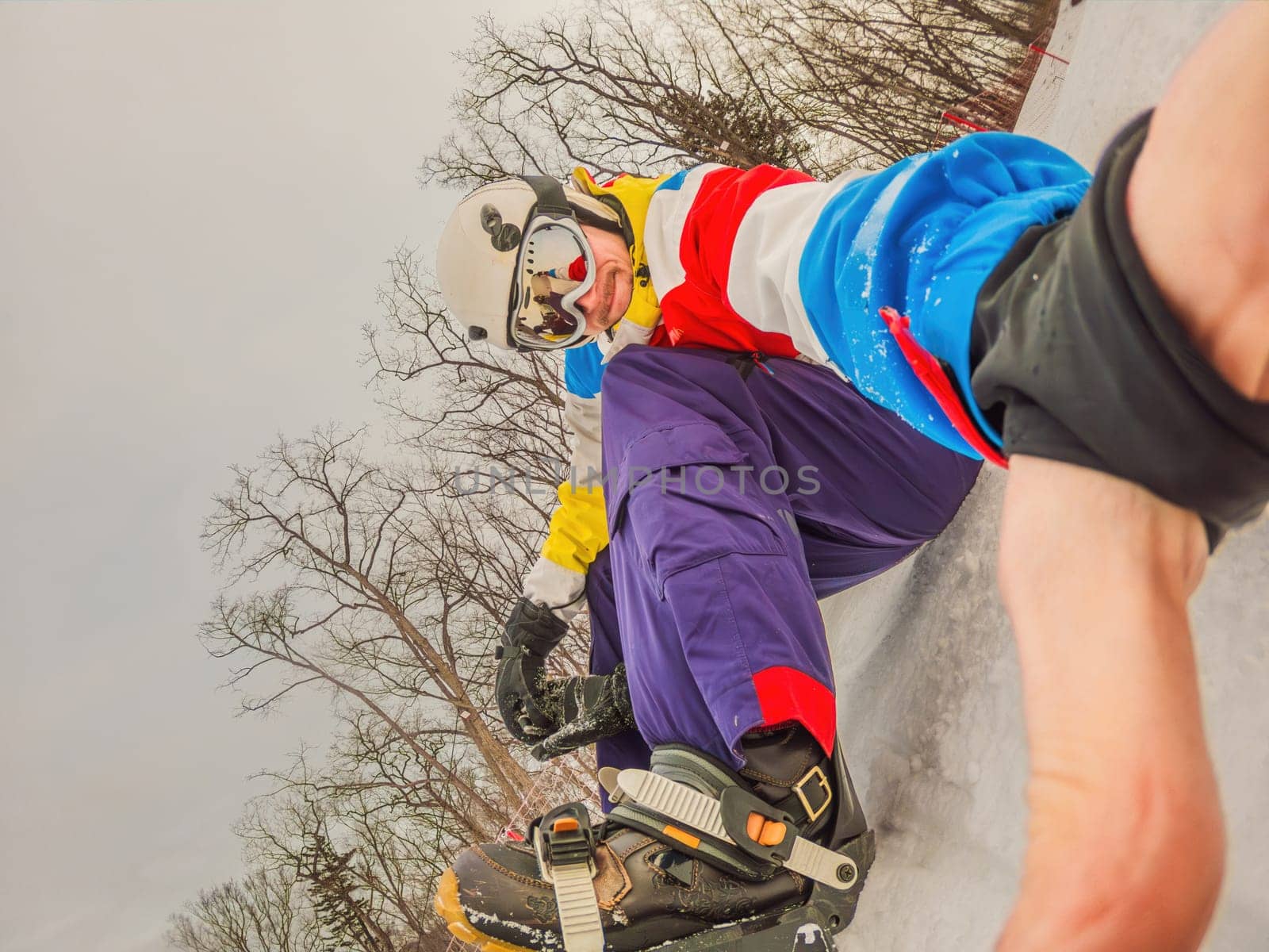 A daring man conquers snowy slopes with style, showcasing skill and thrill as he maneuvers on a snowboard, capturing the essence of winter adventure by galitskaya