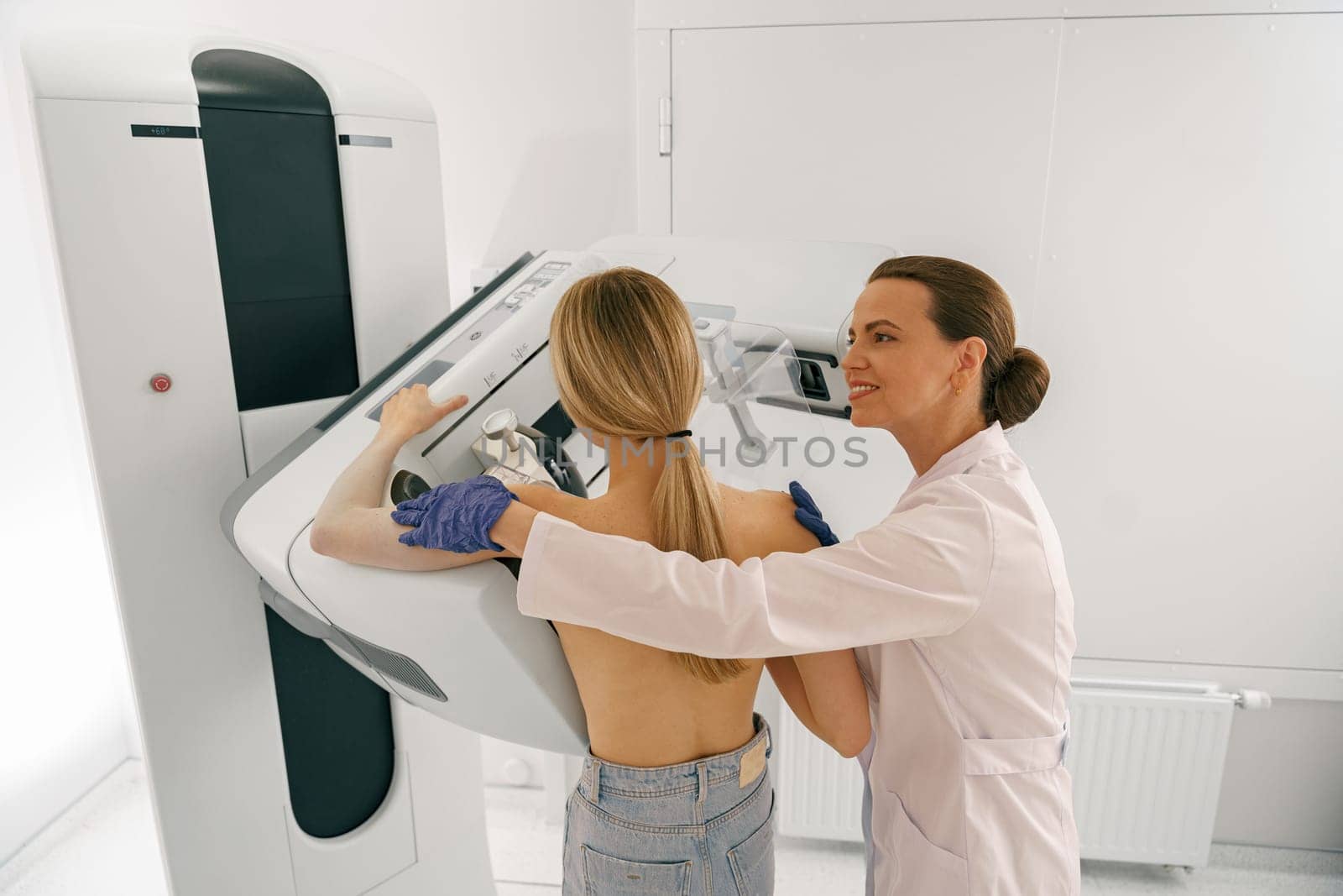 Professional radiologist doing mammogram x ray for young woman to check for breast cancer by Yaroslav_astakhov