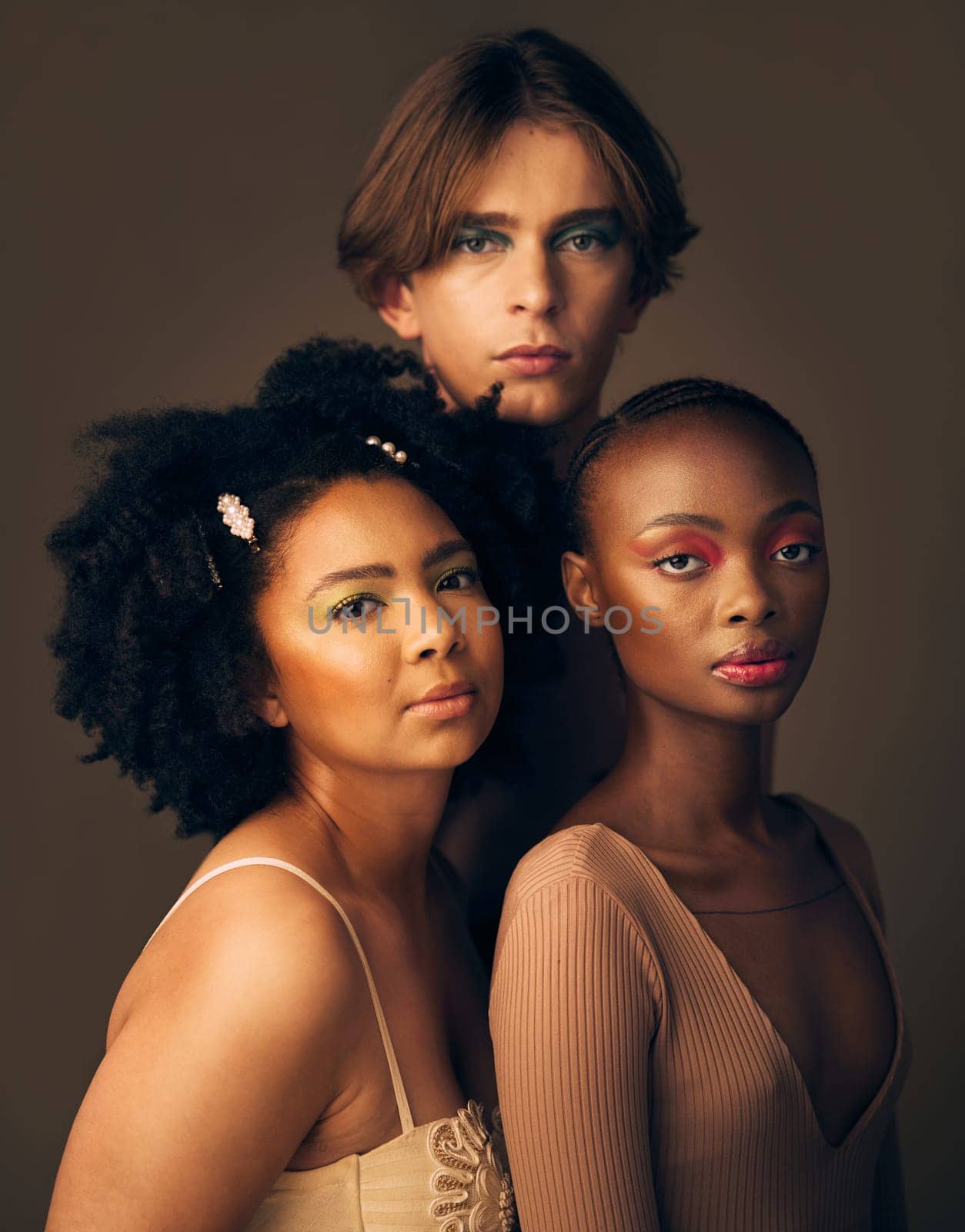 Portrait, skincare or makeup with a man and women in studio on a dark background for beauty or diversity. Face, friends and cosmetics with young people posing for inclusion or artistic freedom.