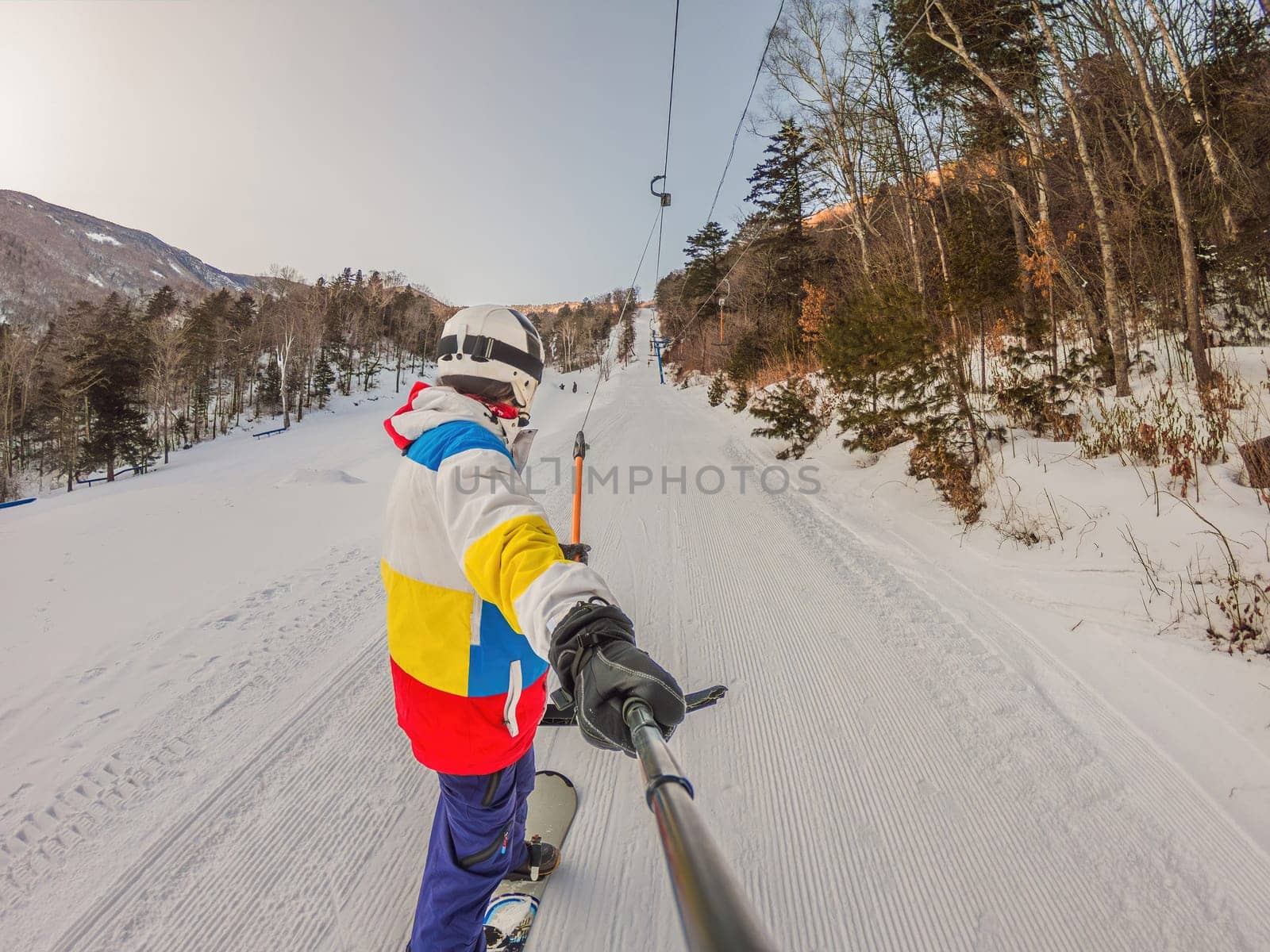 A daring man conquers snowy slopes with style, showcasing skill and thrill as he maneuvers on a snowboard, capturing the essence of winter adventure by galitskaya