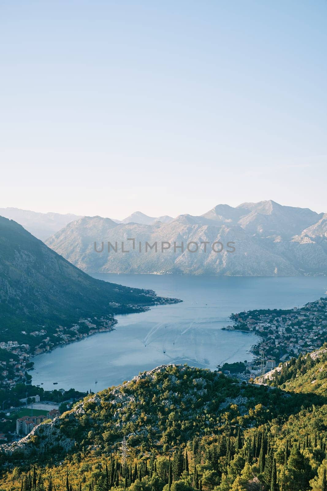 View from a green wooded mountain to the Bay of Kotor, surrounded by mountains. Montenegro by Nadtochiy