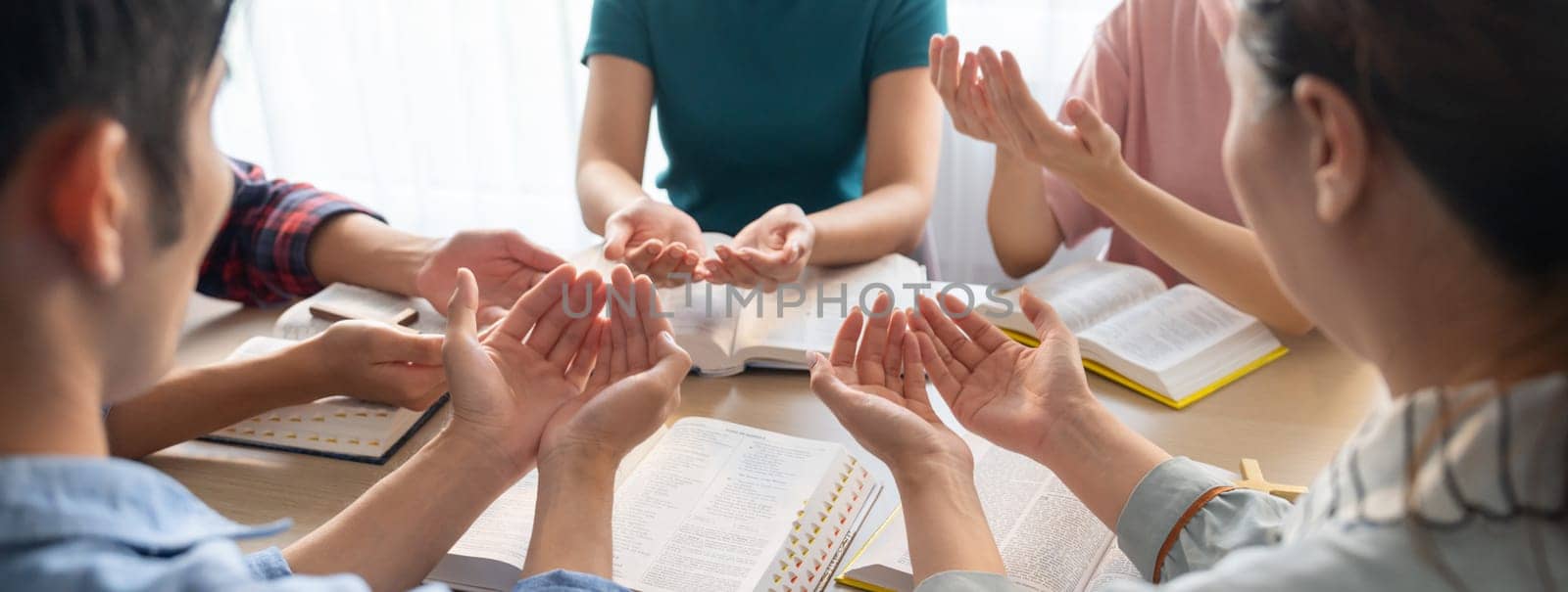 Diversity people hand praying faithfully together on bible book. Burgeoning. by biancoblue