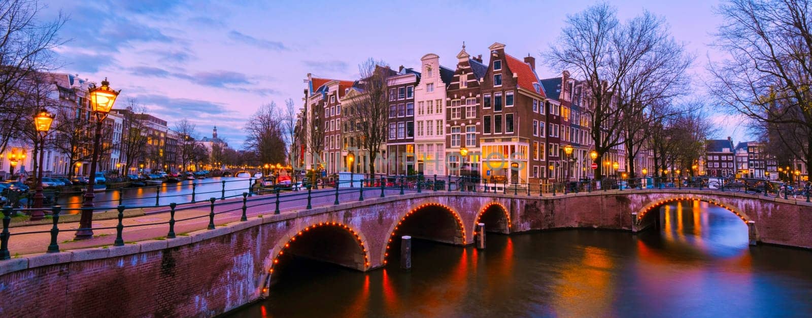 Amsterdam Netherlands canals with lights during evening in December during winter in the Netherlands by fokkebok