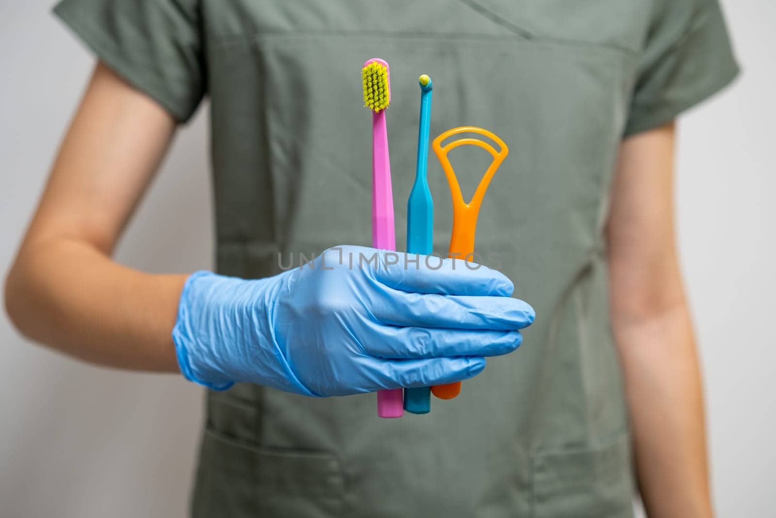 Toothbrushes and Interdental Toothbrushes in dentists hand in rubber gloves. by vladimka