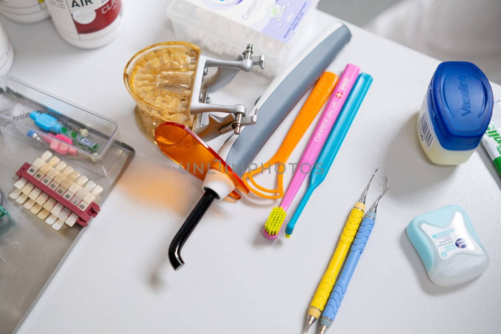 Dental tools, brushes, model jaw on the table in dentist office by vladimka