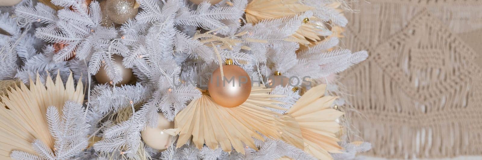 Close up of beautiful white fir branches with shiny golden, silver and white baubles or balls, shiny ornaments and garland lights, home Decoration.Festive new 2024 year. web banner. by YuliaYaspe1979