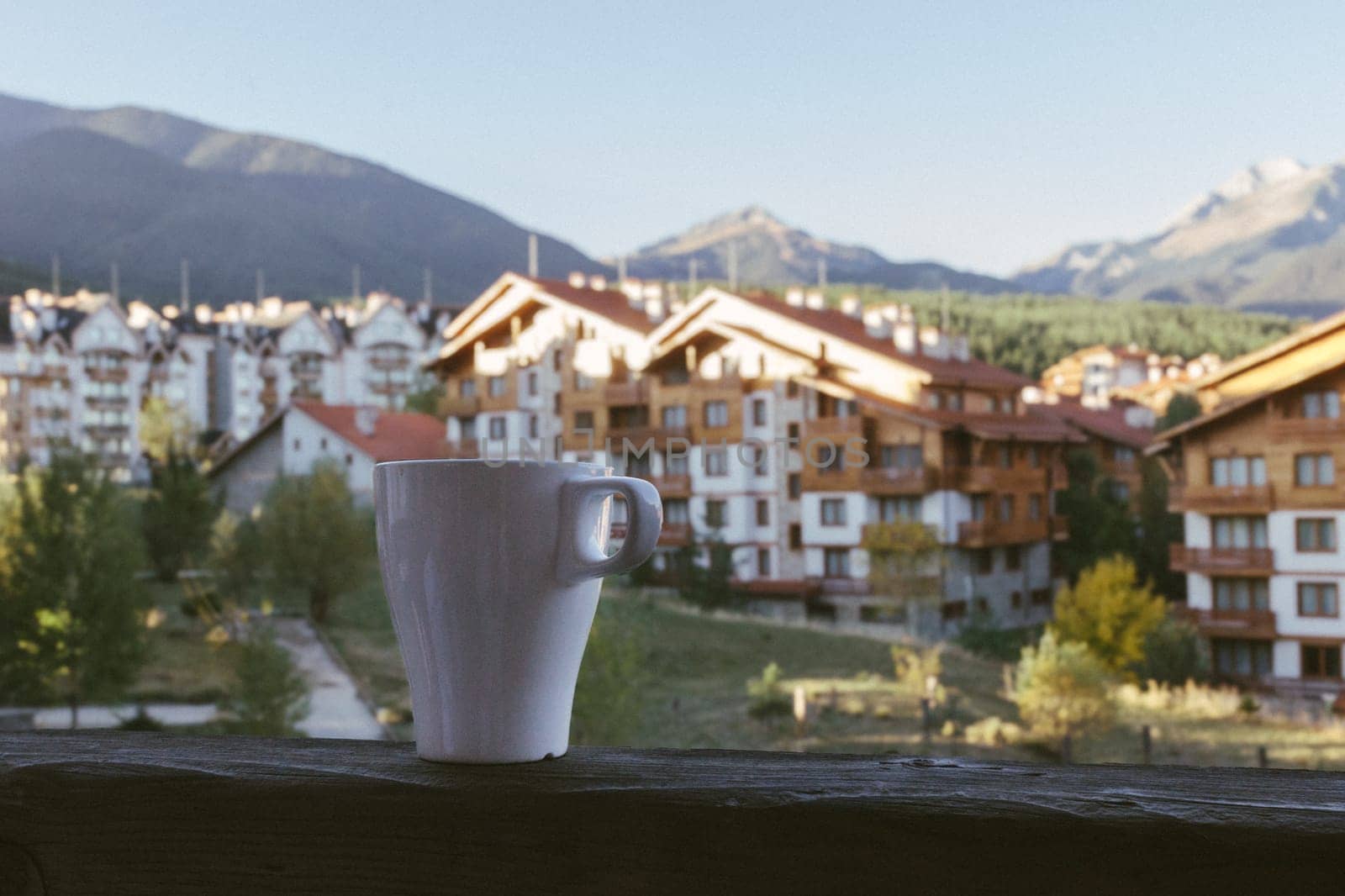 a cup of tea against the backdrop of the hotel and beautiful mountains in Bansko, Bulgaria.