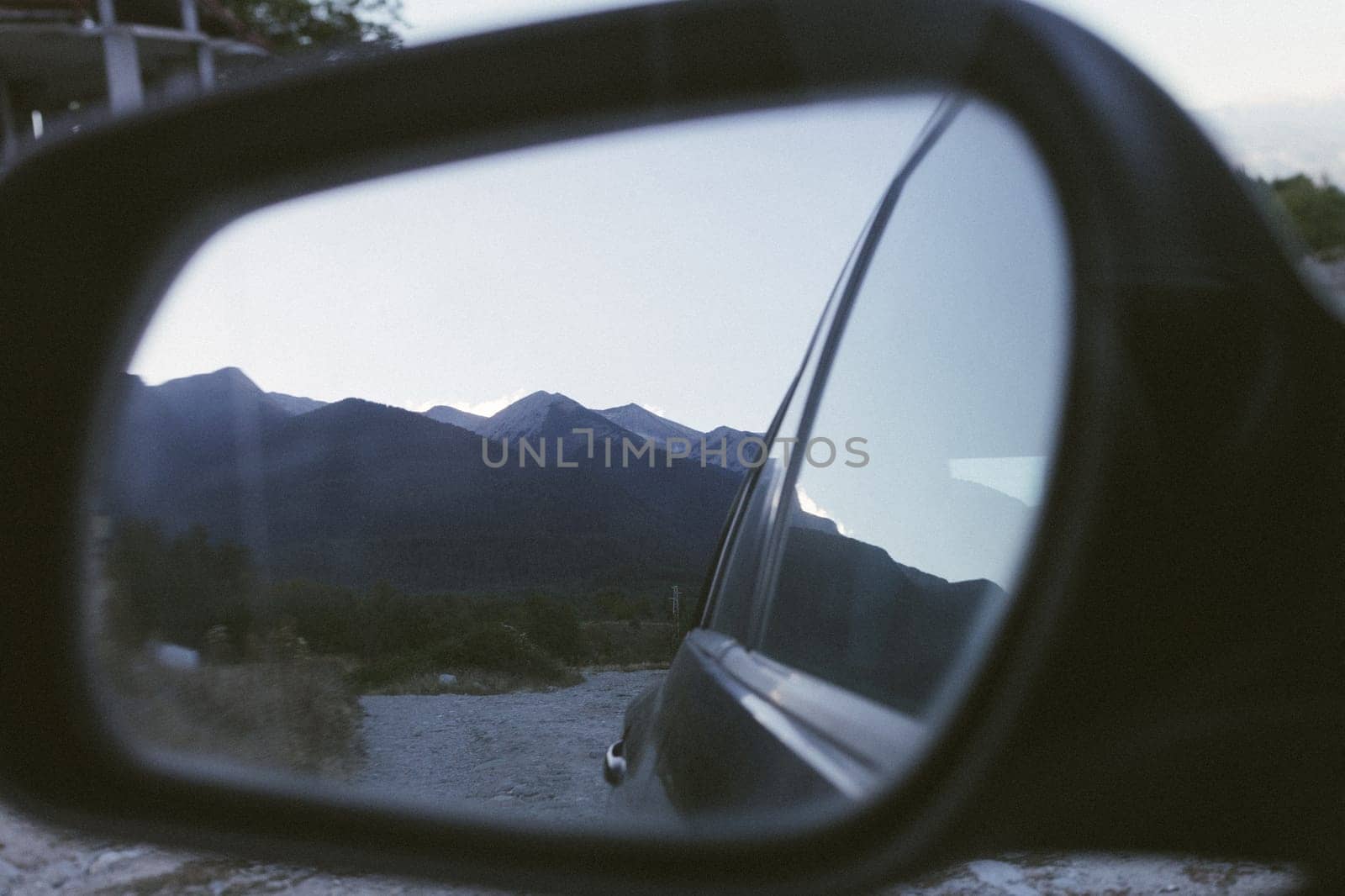 Vehicle side mirror with a view of mountains