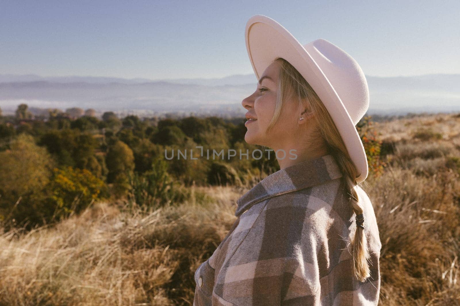 Closeup photo of a young woman enjoying and contemplating the mountains