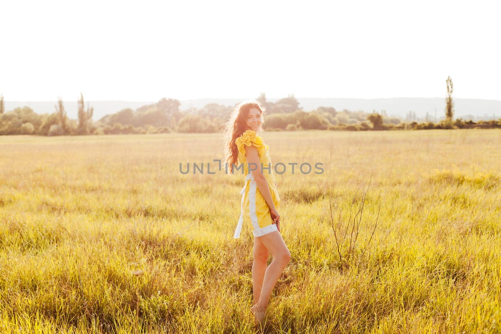 Woman in a field with flowers on a walk