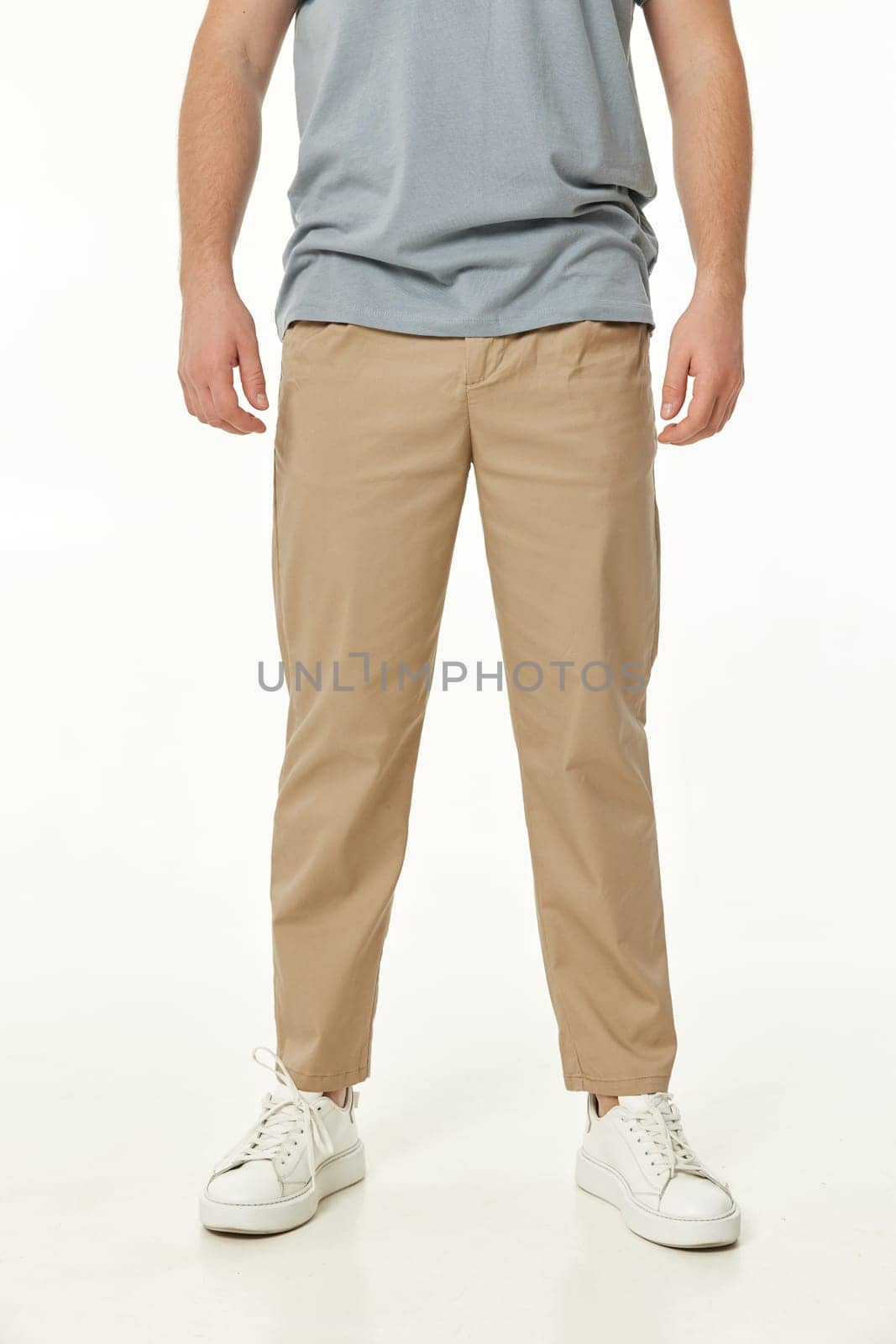 man wearing white sneakers and casual beige pants by erstudio