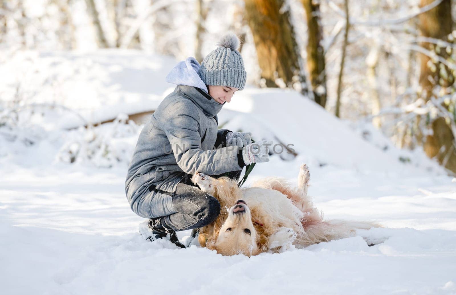 Teenage Girl Plays With Golden Retriever In Winter Forest by tan4ikk1