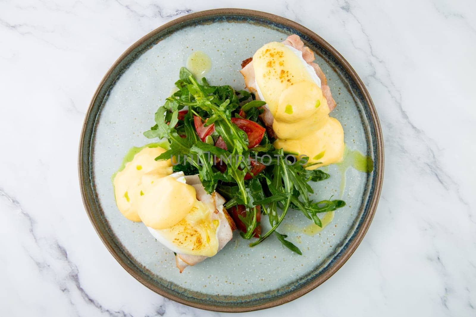 breakfast of arugula and tomato, toast with cheese and poached egg