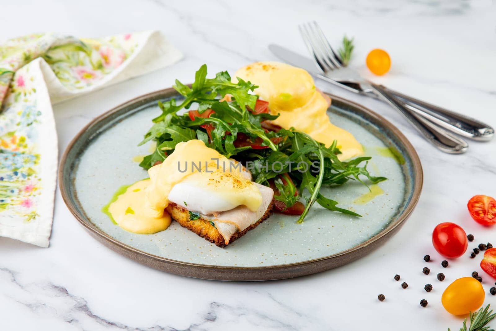 breakfast of arugula and tomato, toast with cheese and poached egg