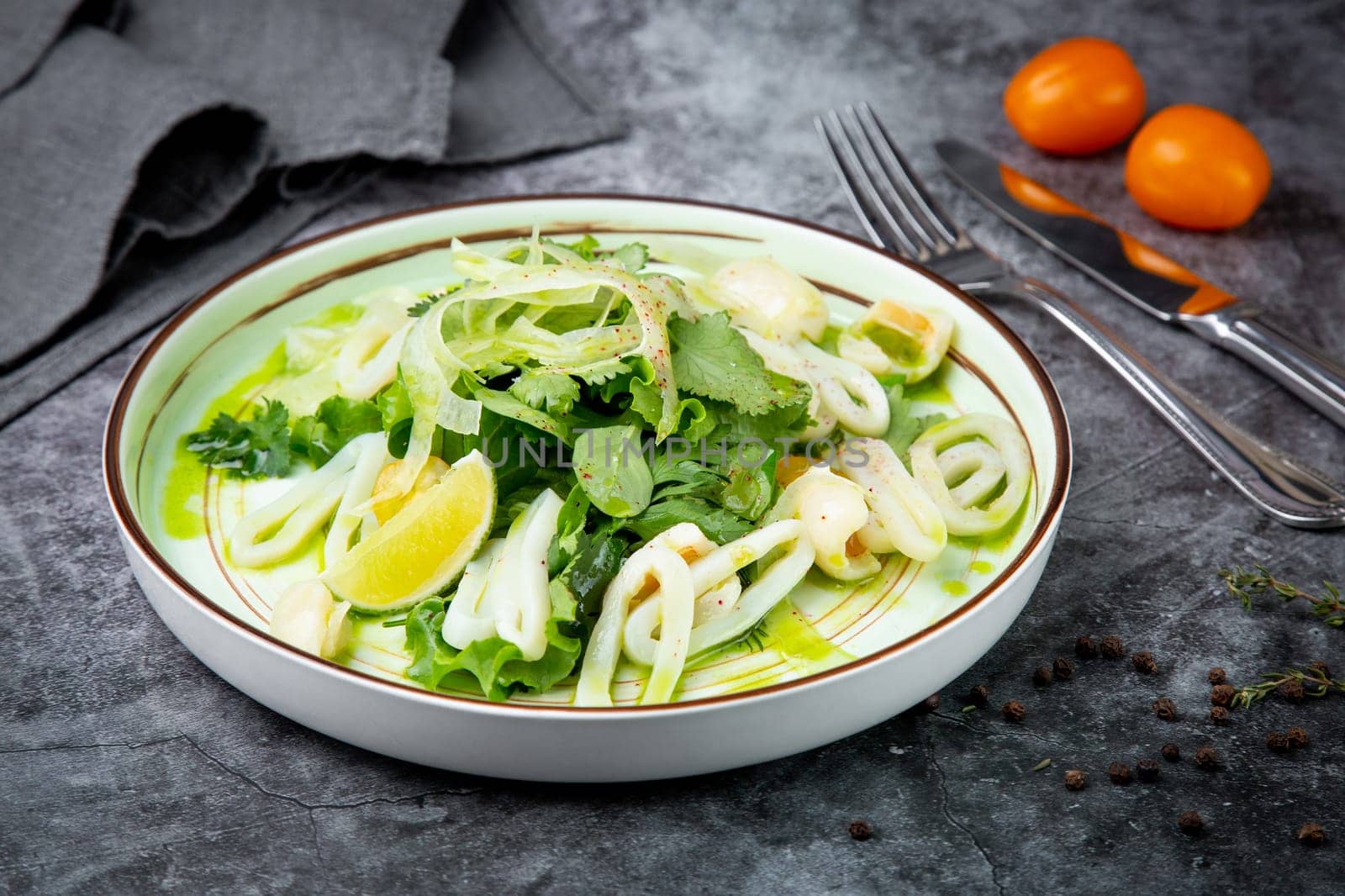 salad with arugula, parsley, lime and squid rings, side view by tewolf