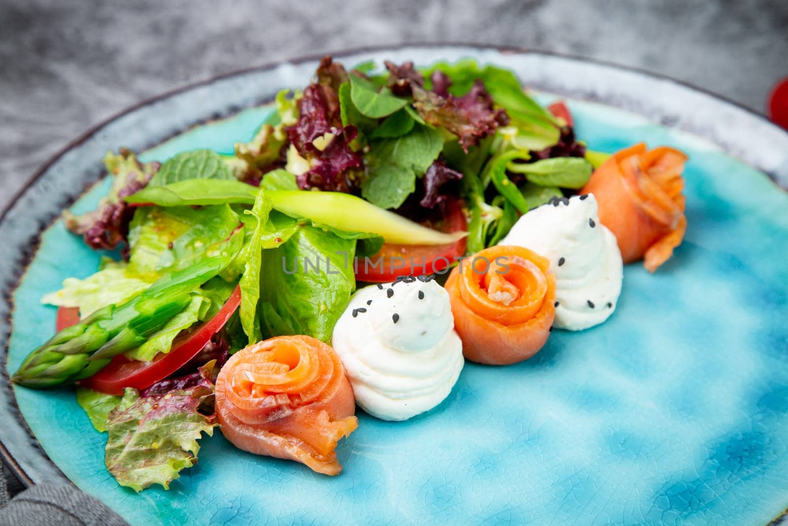 salad of leaves of different types of lettuce and fish rolls, top view by tewolf