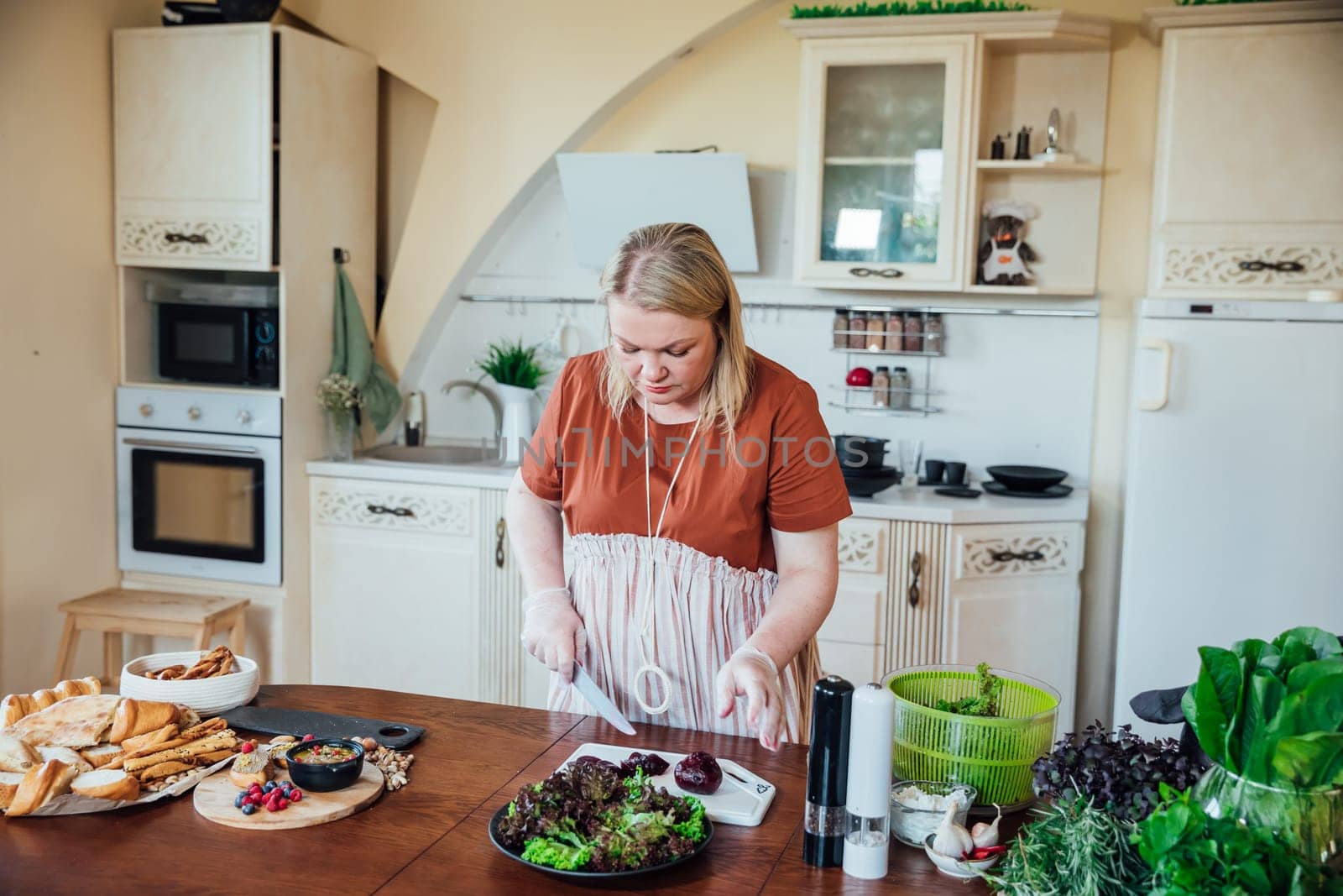 Woman cook at home in kitchen preparing salad for eating