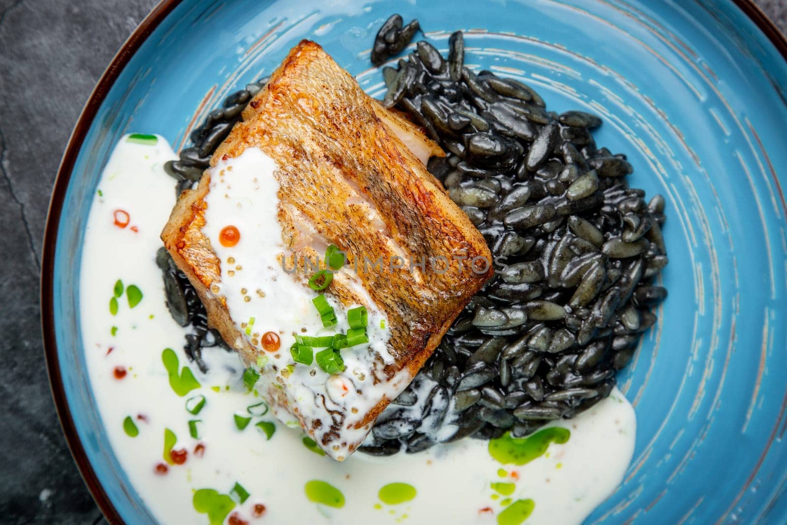 black beans with big fish steak, green onions and cream sauce