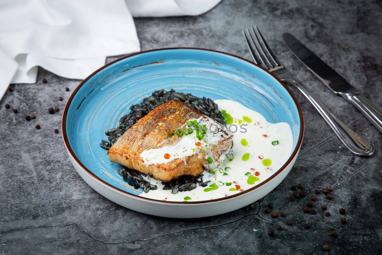 black beans with big fish steak, green onions and cream sauce, top view by tewolf