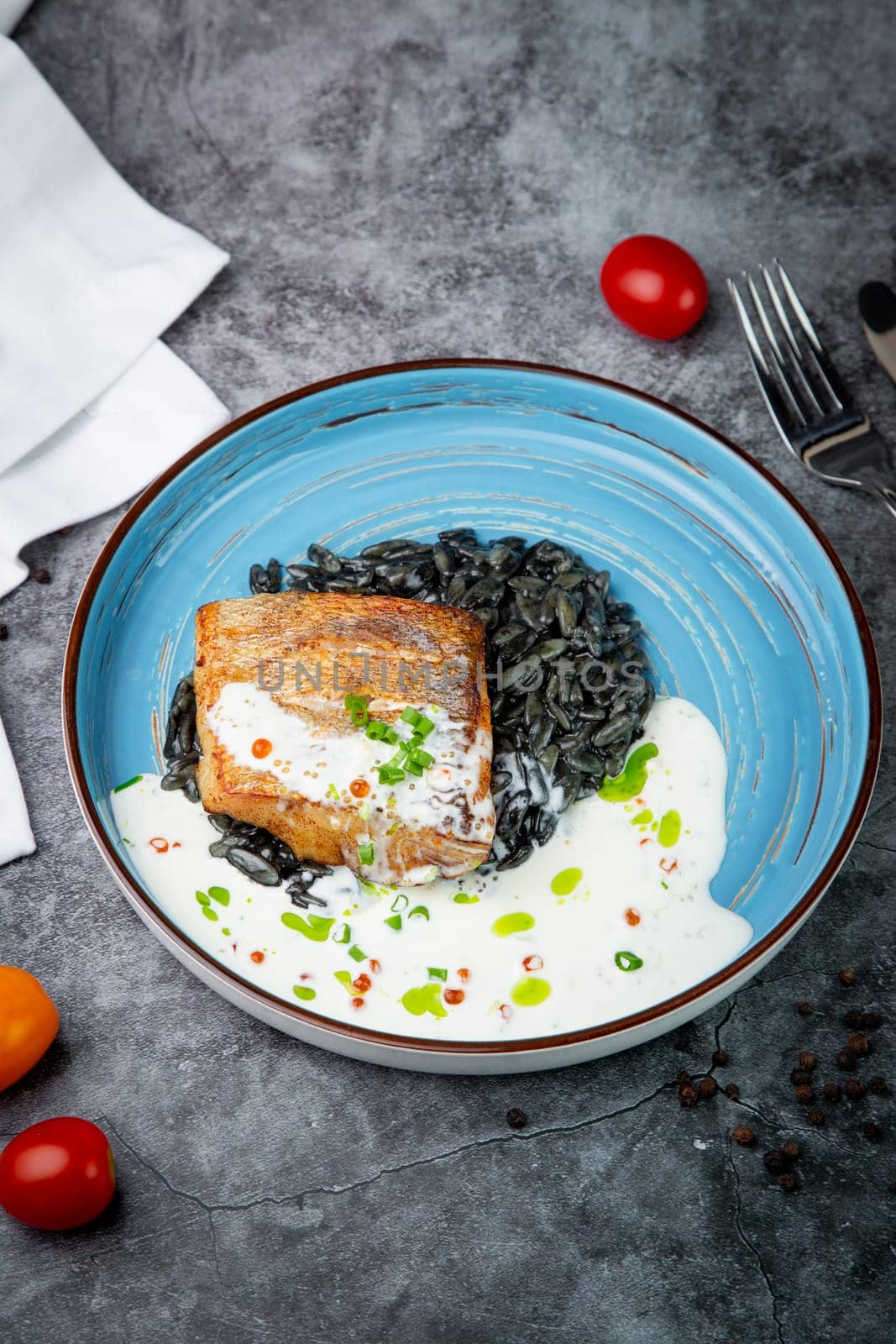 black beans with big fish steak, green onions and cream sauce, top view by tewolf